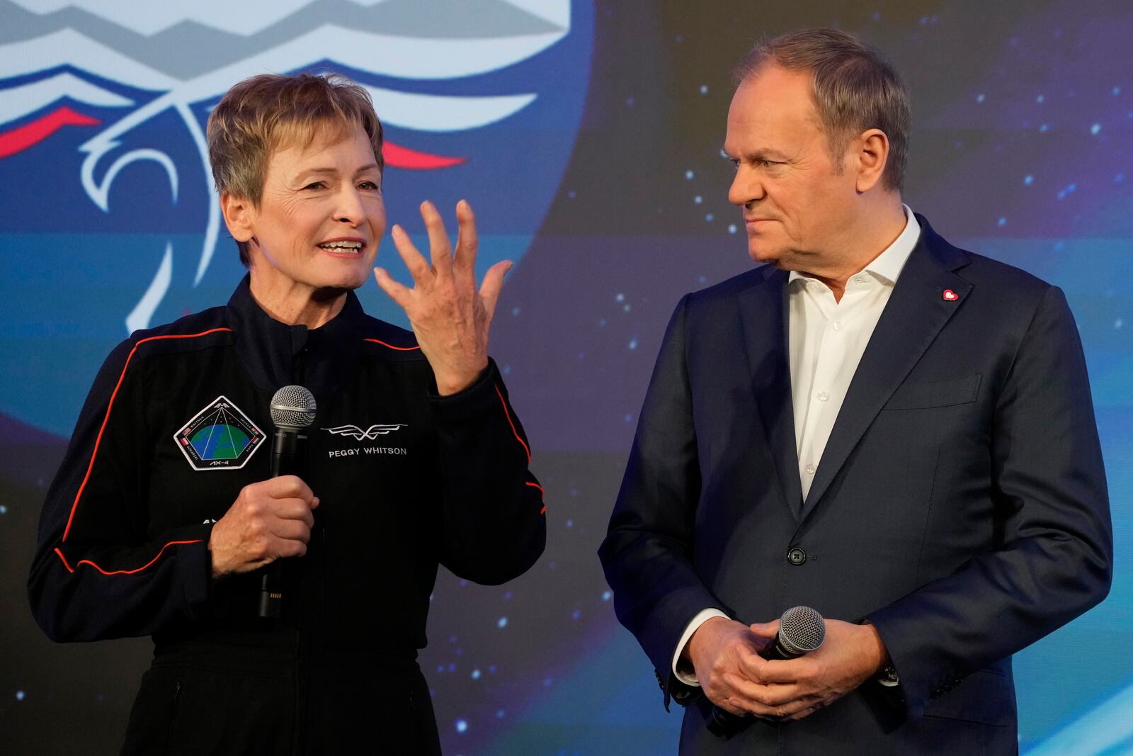 U.S. astronaut Peggy Whitson, commander of the Ax-4 space mission, left, and Poland's Prime Minister Donald Tusk, speak during a media event dedicated to the preparations for the mission, at the Copernicus Science Center in Warsaw, Poland, Wednesday, Feb. 5, 2025. (AP Photo/Czarek Sokolowski)