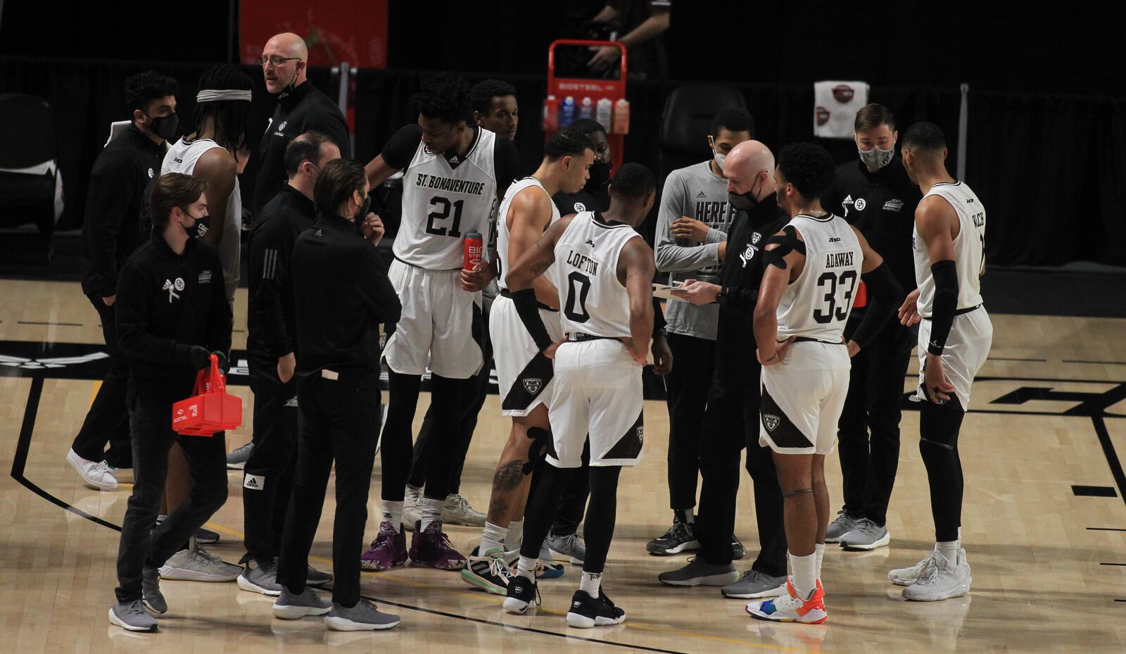 St. Bonaventure huddles around coach Mark Schmidt during a game against Duquesne in the Atlantic 10 tournament on March 5, 2021, at the Siegel Center in Richmond, Va. David Jablonski/Staff