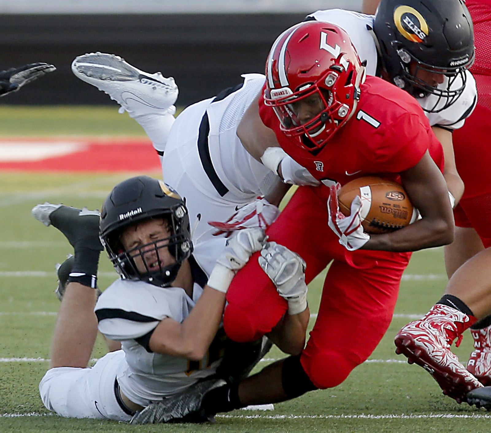 Fairfield slotback Chico Robinson is brought down by two Centerville defenders during the Indians’ 30-23 defeat Friday night in the Skyline Chili Crosstown Showdown at Fairfield Stadium. CONTRIBUTED PHOTO BY E.L. HUBBARD