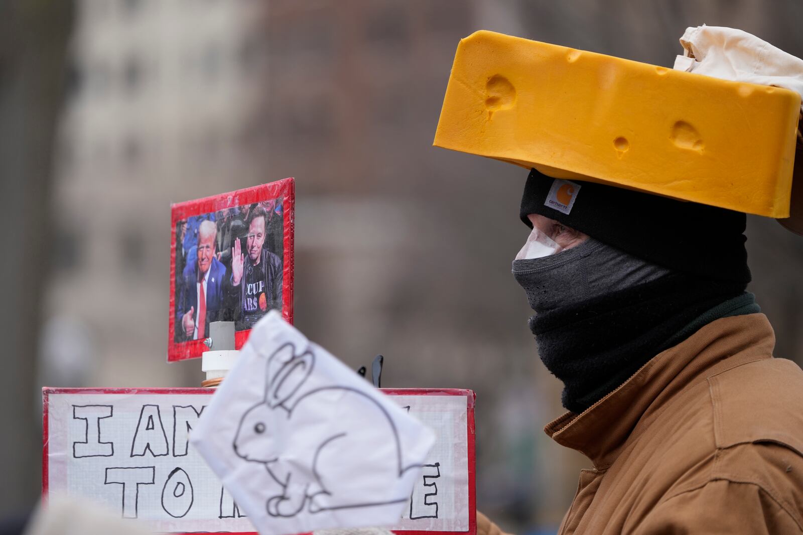 A person holds a sign during a protest outside the Wisconsin Capitol Wednesday, Feb. 5, 2025, in Madison, Wis. (AP Photo/Morry Gash)