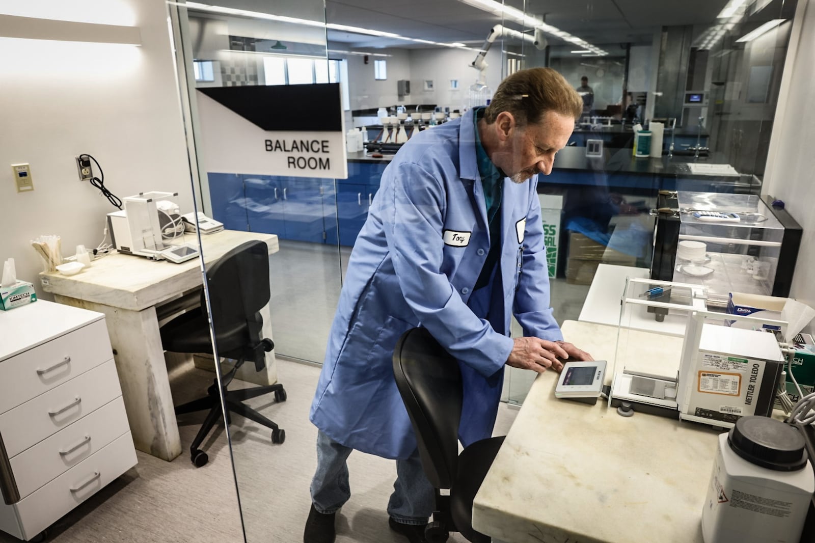 Montgomery County Environmental chemist Tony Miley uses a scale to weigh chemicals at the new Montgomery County Environmental Service lab. JIM NOELKER/STAFF