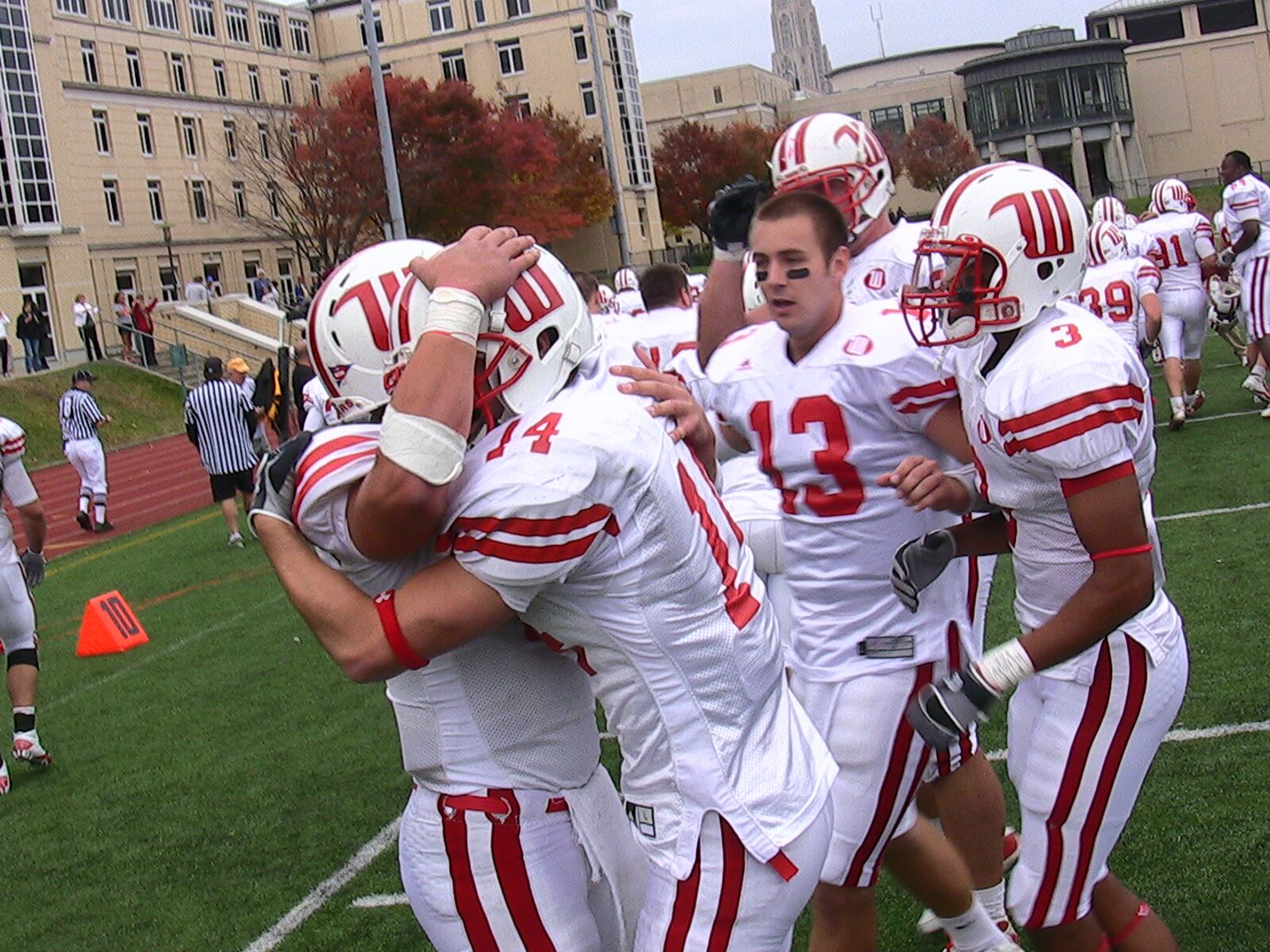 Wittenberg quarterback Ben Zoeller (left) hugs wide receiver Josh McKee after the two connected on the game-winning touchdown pass in overtime Saturday. The Tigers beat Carnegie Mellon 27-21 at Gesling Stadium in Pittsburgh. Staff photo by David Jablonski