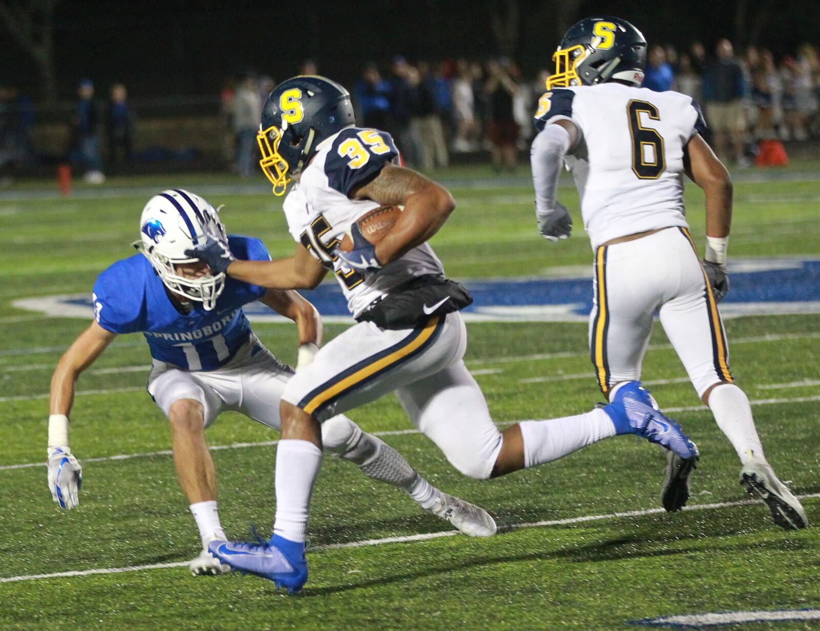 Jeff Tolliver of Springfield (with ball) takes on Springboro defender Josh Collins. Springfield defeated host Springboro 23-0 in a Week 7 high school football game on Friday, Oct. 11, 2019. MARC PENDLETON / STAFF