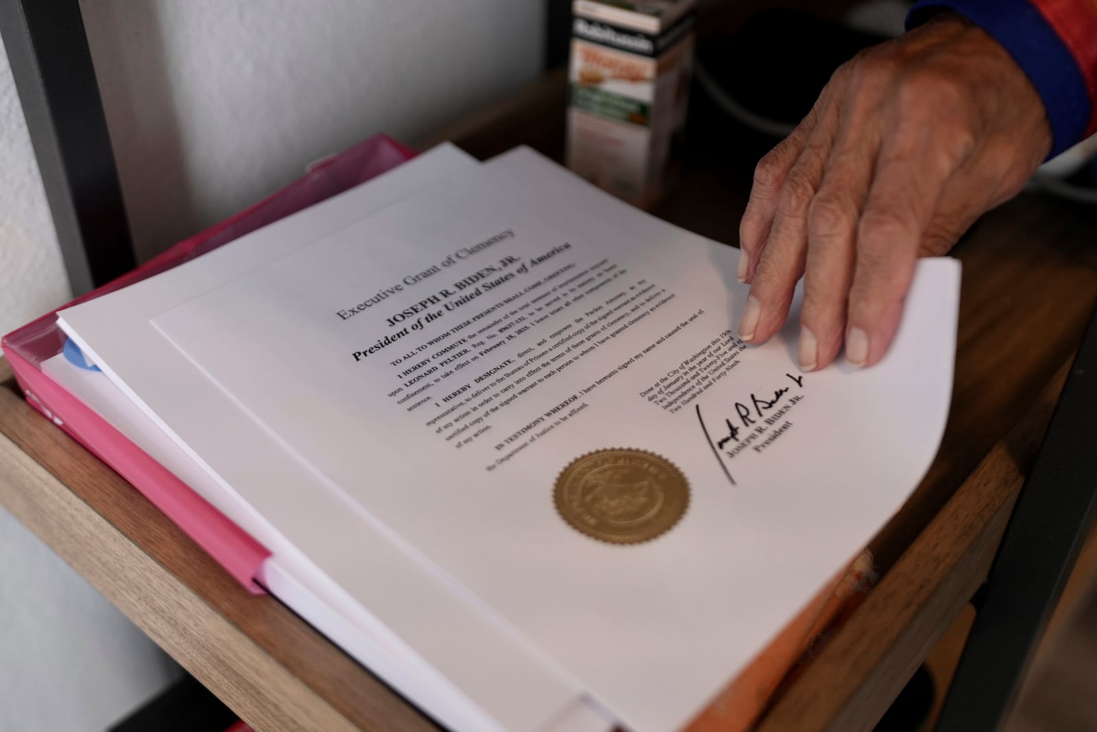 Leonard Peltier holds a copy of his commutation in Belcourt, N.D, on Tuesday, Feb. 25, 2025. (AP Photo/Mark Vancleave)