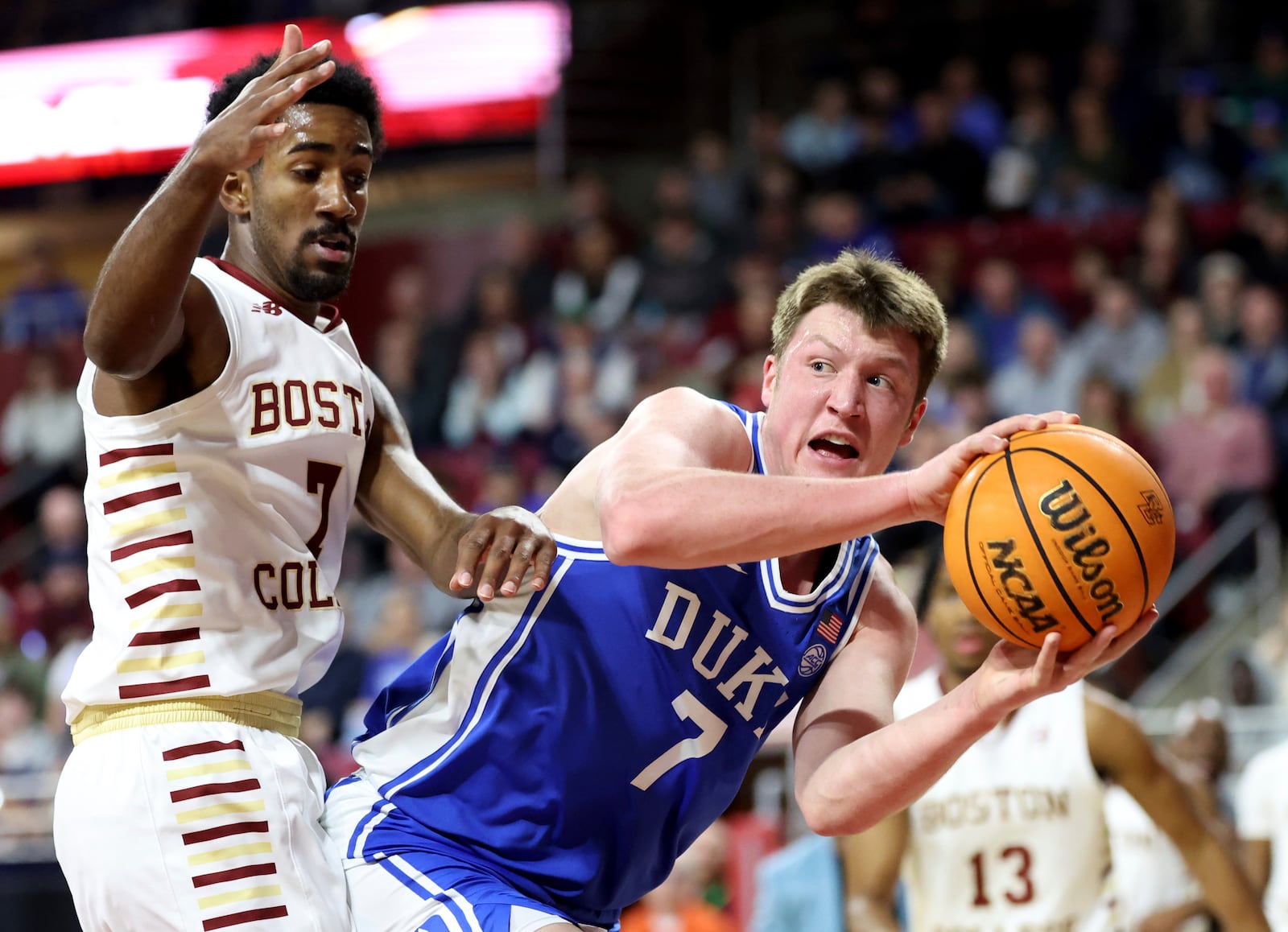 Duke guard Kon Knueppel (7) looks to pass off the ball around Boston College guard Joshua Beadle (7) during the first half of an NCAA college basketball game Saturday, Jan. 18, 2025, in Boston. (AP Photo/Mark Stockwell)