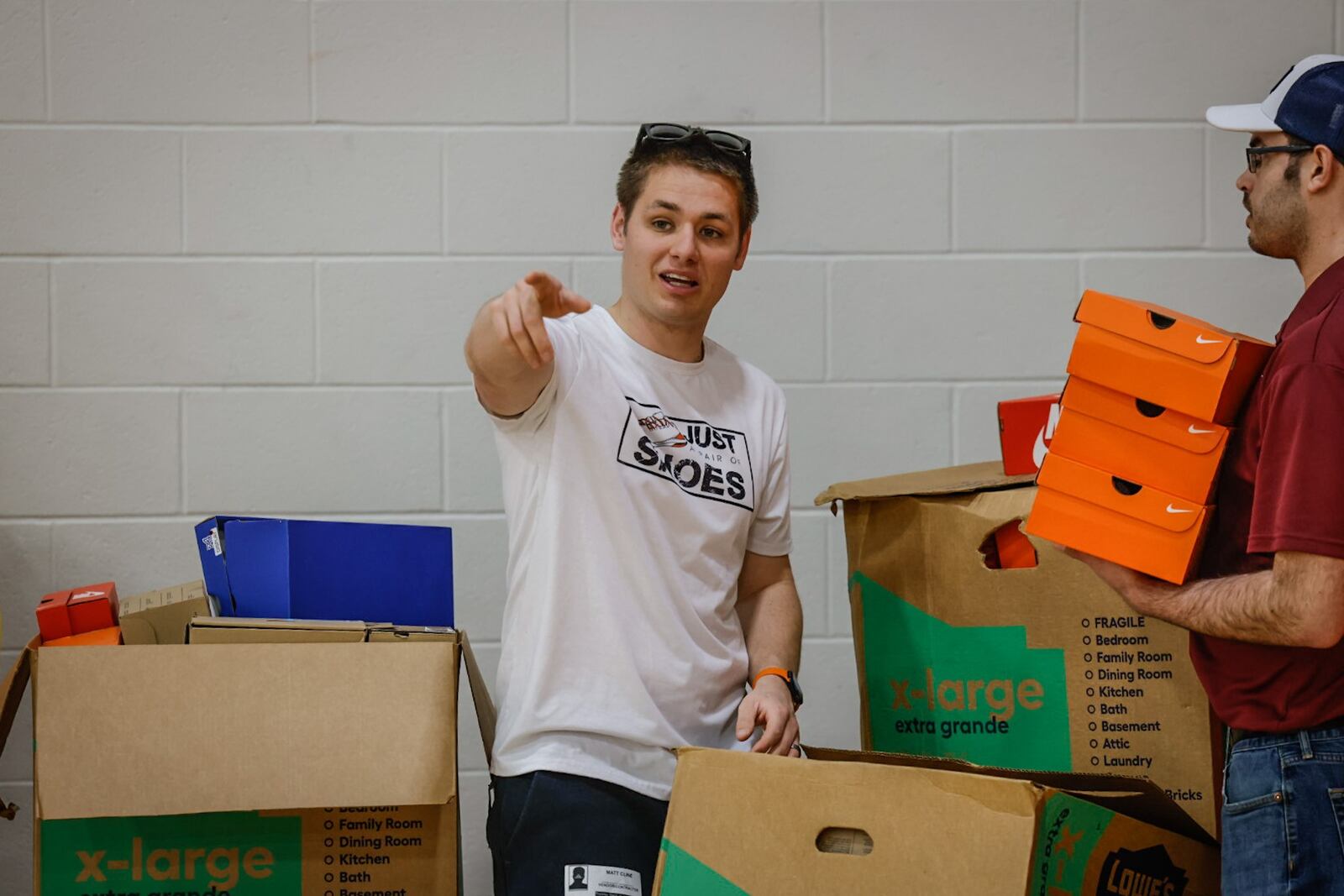 Matt Cline is the founder/director of the nonprofit, Just a Pair of Shoes, prompts volunteers at Northridge Schools. JIM NOELKER/STAFF