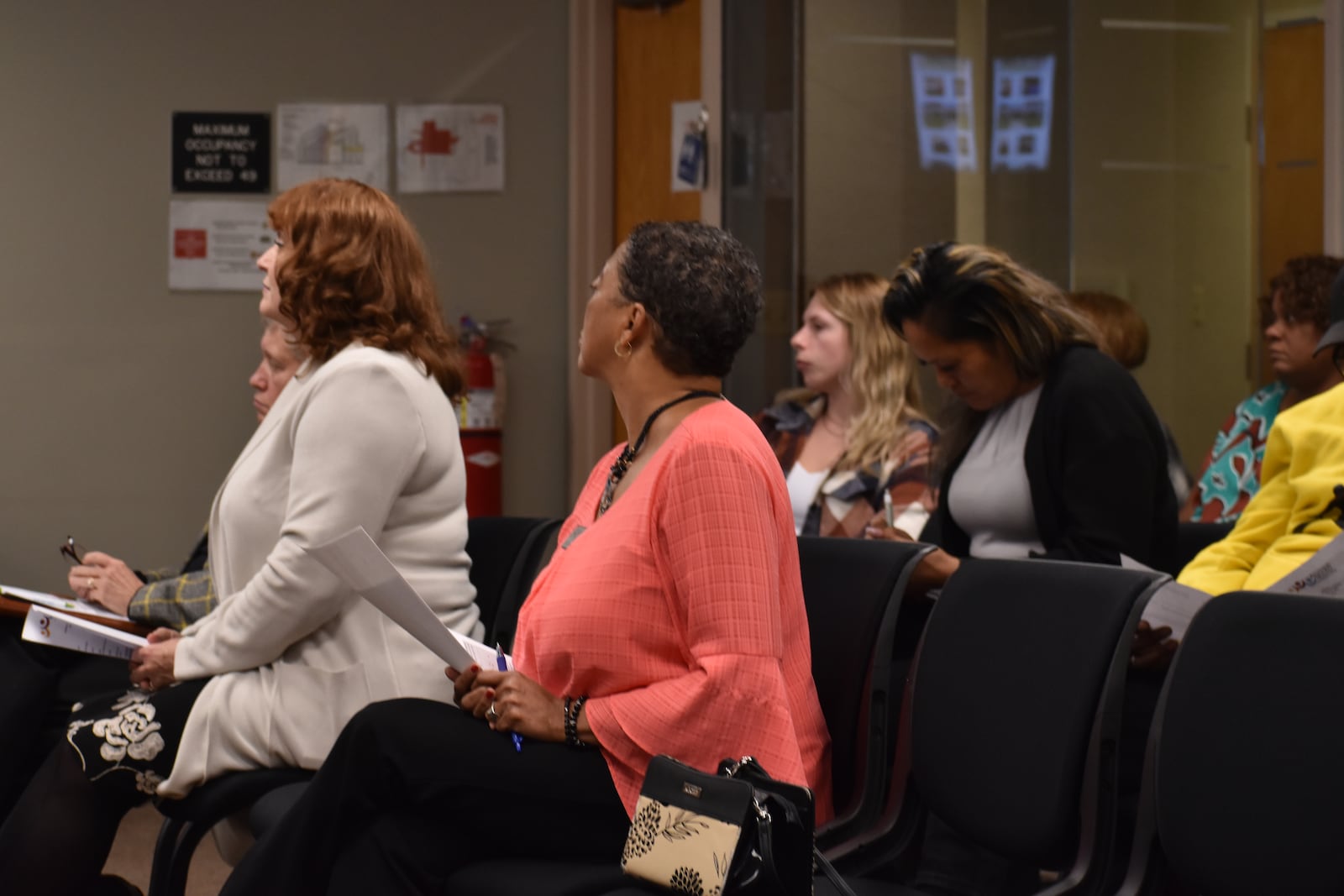 Audience members, including staff from Montgomery County Alcohol, Drug Addiction and Mental Health Services (ADAMHS) and representatives from multiple providers for mental health and substance use disorder treatment services, listen in on a presentation during the Nov. 20 board meeting. SAM WILDOW/STAFF