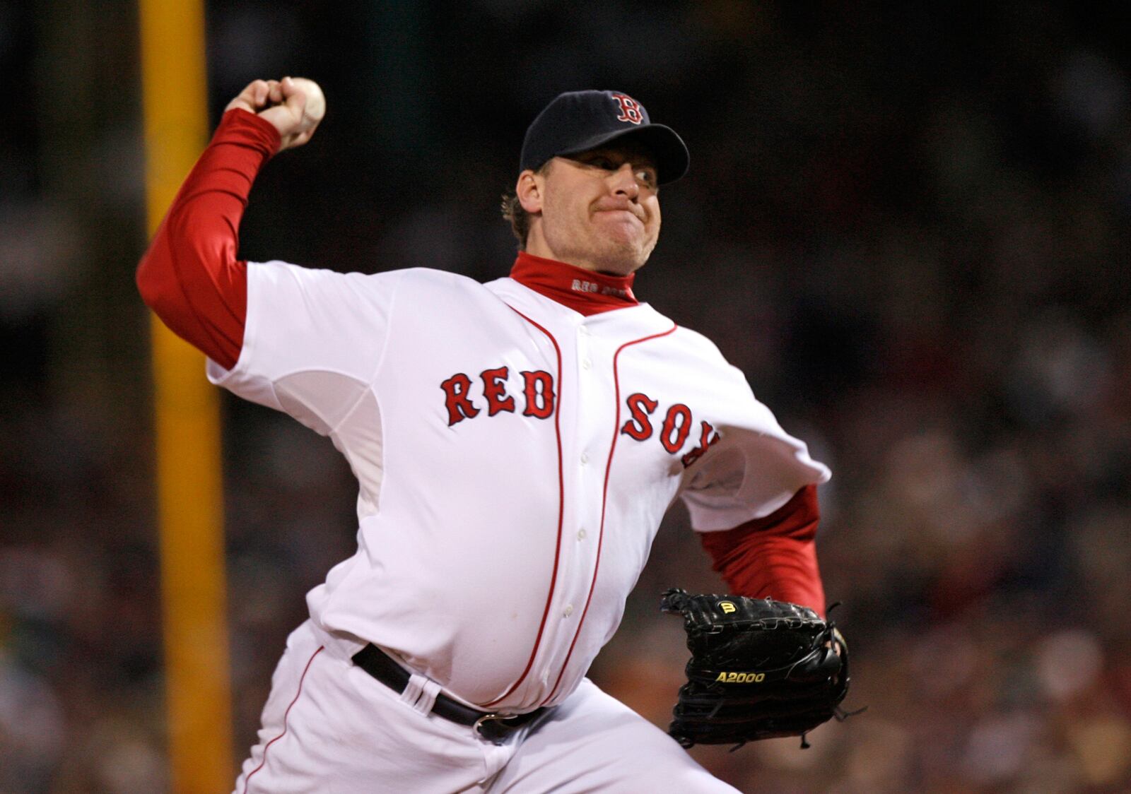 FILE - In this Oct. 25, 2007, file photo, Boston Red Sox's Curt Schilling pitches against the Colorado Rockies in Game 2 of the baseball World Series at Fenway Park in Boston. Like many baseball writers, C. Trent Rosecrans viewed the Hall of Fame vote as a labor of love. The results of the 2021 vote will be announced Tuesday, Jan. 26, 2021, and Rosecrans was not alone in finding the task particularly agonizing this time around. With Schilling's candidacy now front and center — and Barry Bonds and Roger Clemens still on the ballot as well — voters have had to consider how much a player’s off-field behavior should affect his Hall of Fame chances. (AP Photo/Kathy Willens, File)