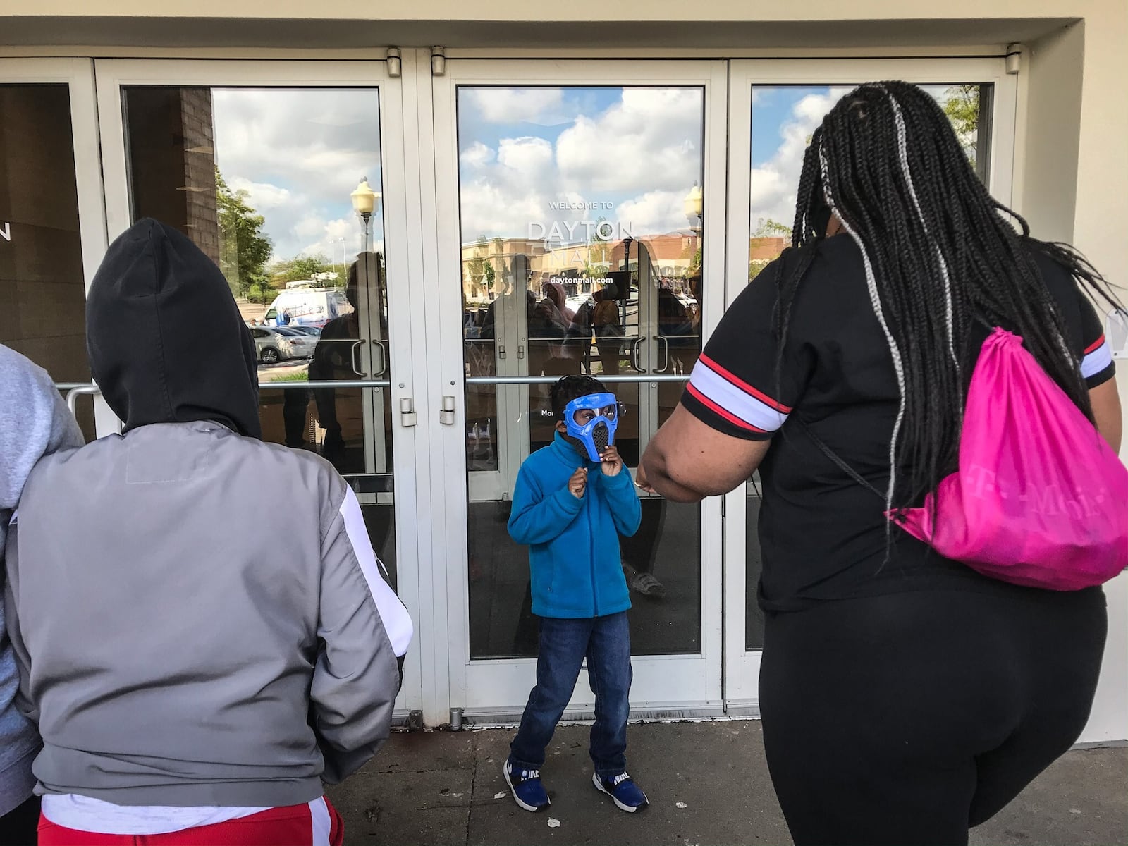 Around 300 people went shopping Tuesday morning at the Dayton Mall. The doors opened at 11 a.m. for 50 people waiting at the doors. About half the stores appeared to be open and about half the shoppers in the mall were wearing masks. JIM NOELKER/STAFF