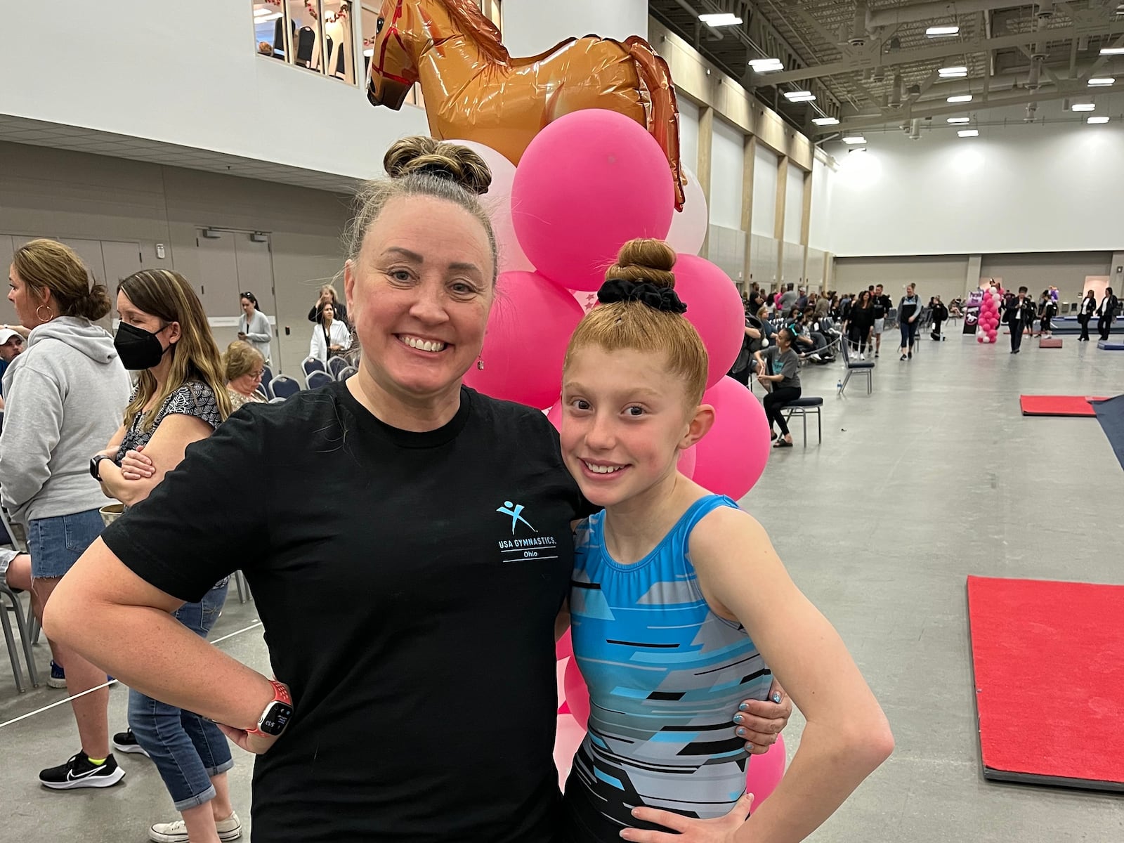 LaPeer (L) with one of her gymnasts, Emma Doherty. Doherty had surgery to repair a broken arm last year and LaPeer made sure she took the "Smurf" good luck charm with her to surgery.