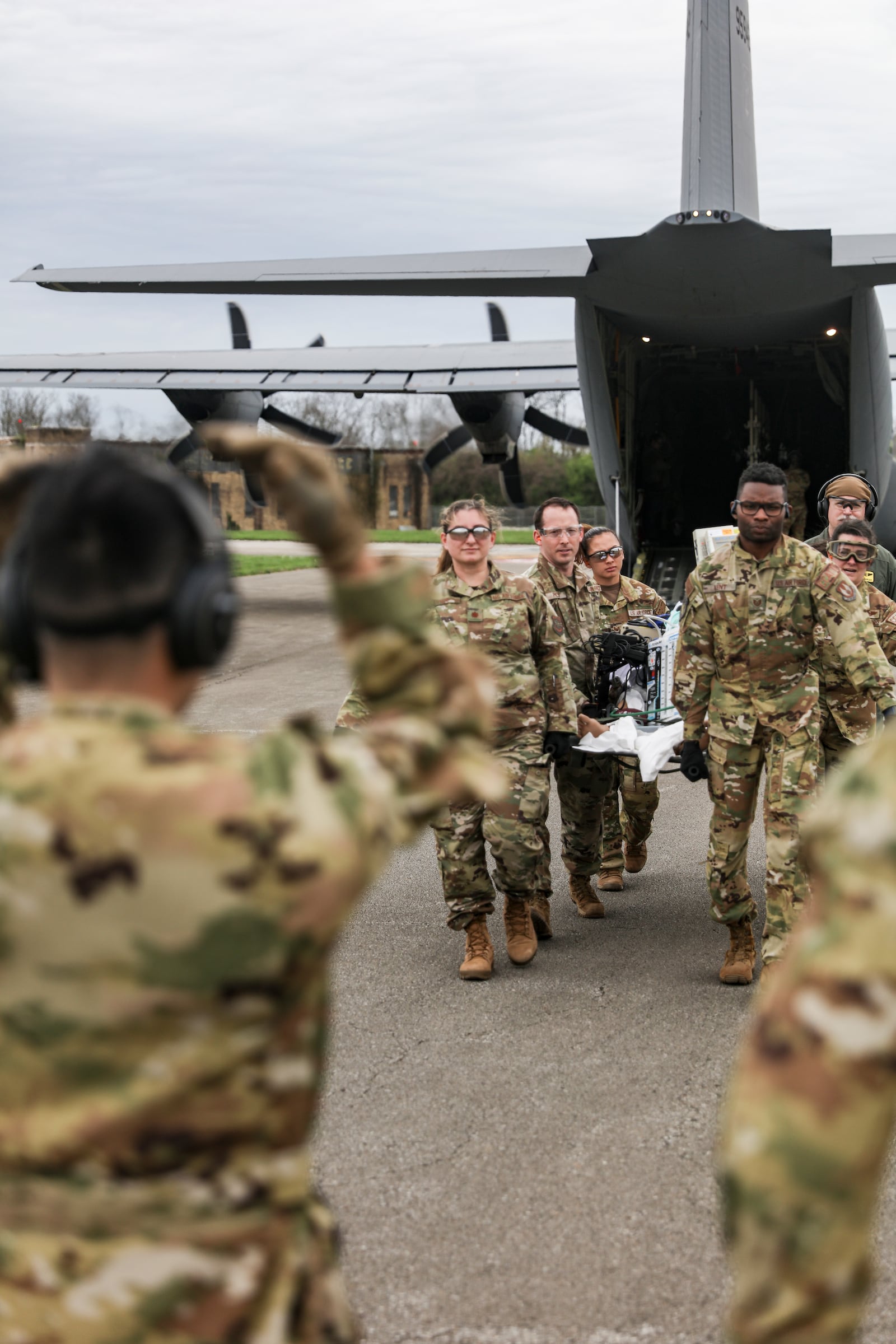 Air Force critical care air transport teams head back to the aircraft to offload mannequin patients at the Cincinnati Municipal Airport, April 6.  (U.S. Air Force photo by Master. Sgt. Patrick O’Reilly)