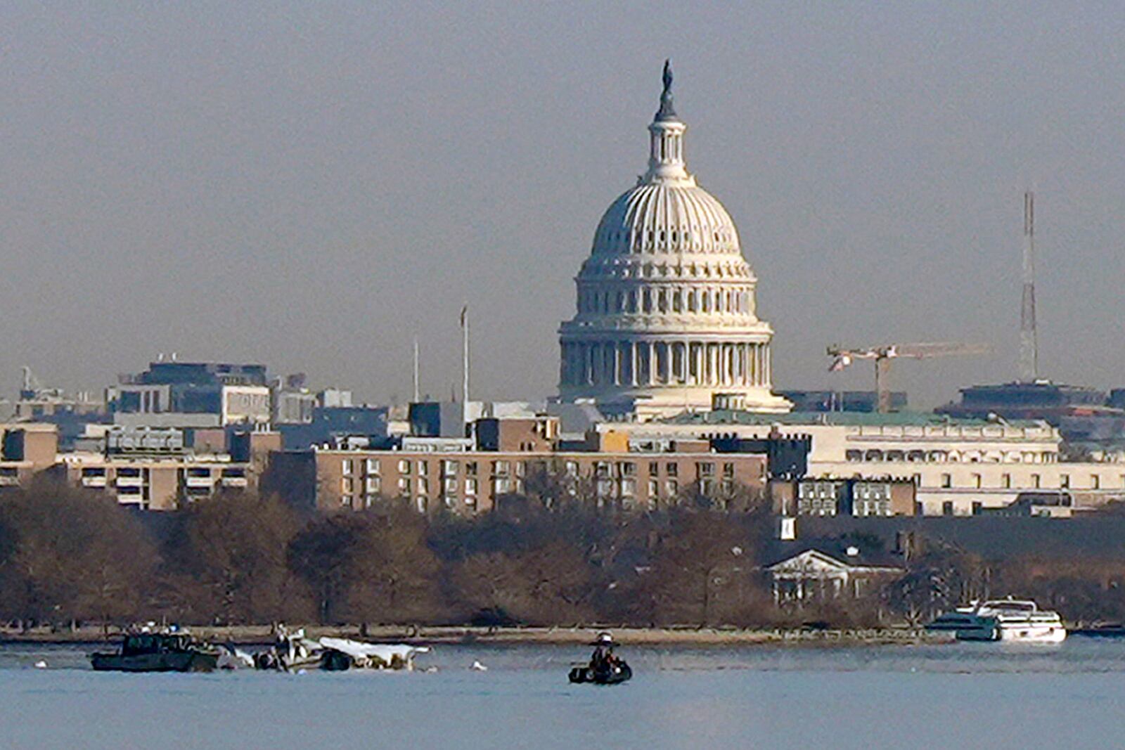 Search and rescue efforts are seen around a wreckage site in the Potomac River from Ronald Reagan Washington National Airport, early Thursday morning, Jan. 30, 2025, in Arlington, Va. (AP Photo/Carolyn Kaster)