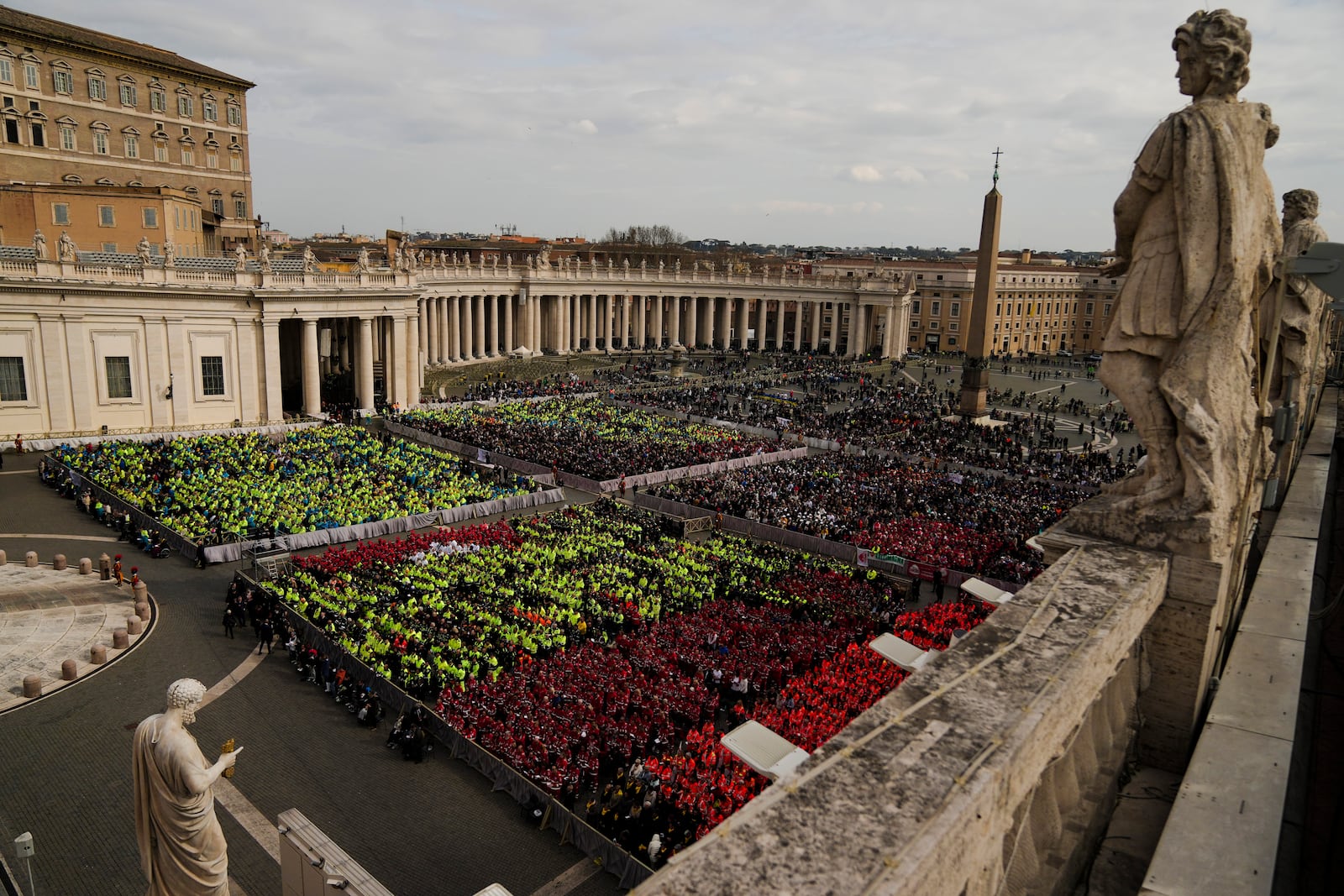 Members of different organizations of volunteers follow Cardinal Michael Czerny, delegate of Pope Francis who is being treated for pneumonia at Rome's Agostino Gemelli Polyclinic, celebrating a mass for the world of volunteers in St. Peter's Square at The Vatican, Sunday, March 9, 2025. (AP Photo/Francisco Seco)