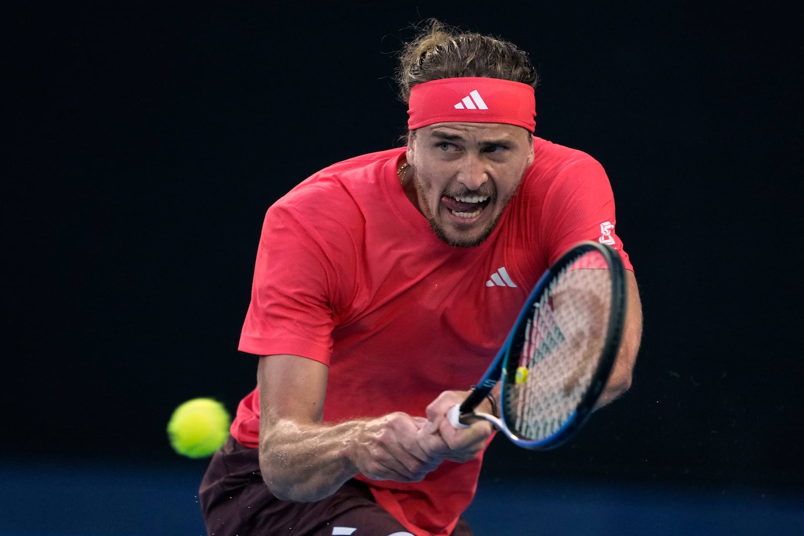 Alexander Zverev of Germany plays a backhand return to Jannik Sinner of Italy during the men's singles final at the Australian Open tennis championship in Melbourne, Australia, Sunday, Jan. 26, 2025. (AP Photo/Ng Han Guan)