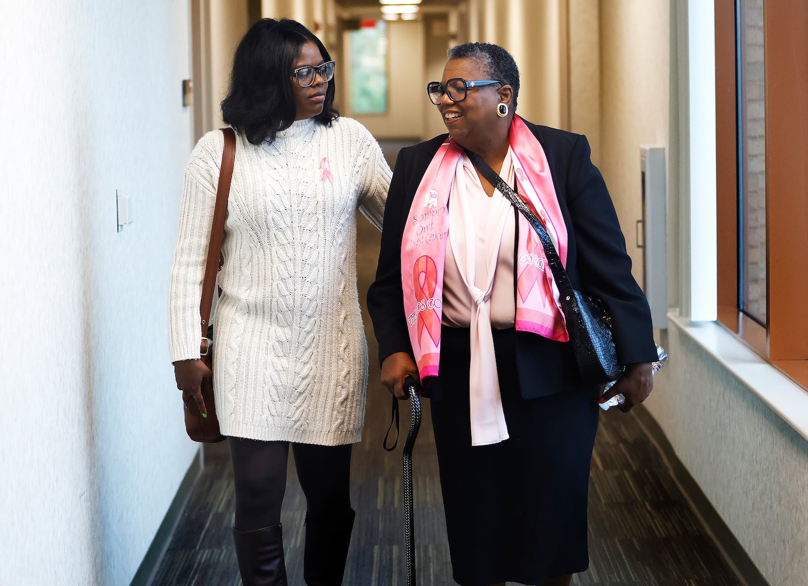 Marva (right) and Kelly Hughes, a mother and daughter from Dayton who are both breast cancer survivors. They were both treated by the same cancer team at Miami Valley Hospital North. 
MARSHALL GORBY\STAFF