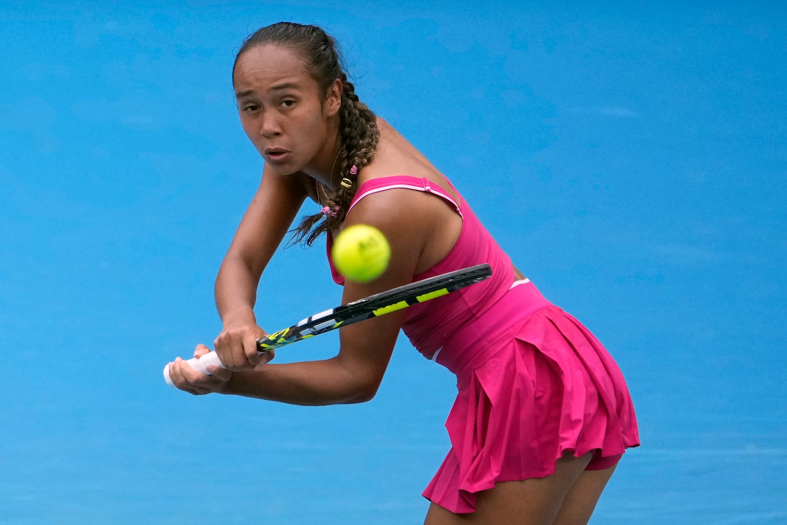 Leylah Fernandez of Canada plays a backhand return to Yuliia Starodubtseva of Ukraine during their first round match at the Australian Open tennis championship in Melbourne, Australia, Sunday, Jan. 12, 2025. (AP Photo/Asanka Brendon Ratnayake)