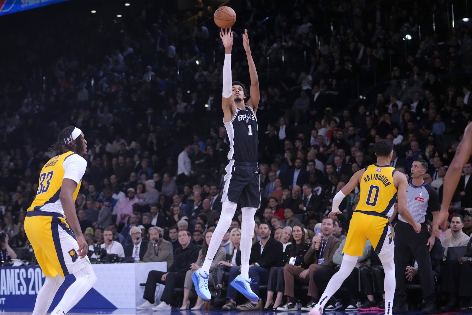 San Antonio Spurs center Victor Wembanyama (1) shoots against the Indiana Pacers during the second half of a Paris Games 2025 NBA basketball game in Paris, Thursday, Jan. 23, 2025. (AP Photo/Thibault Camus)