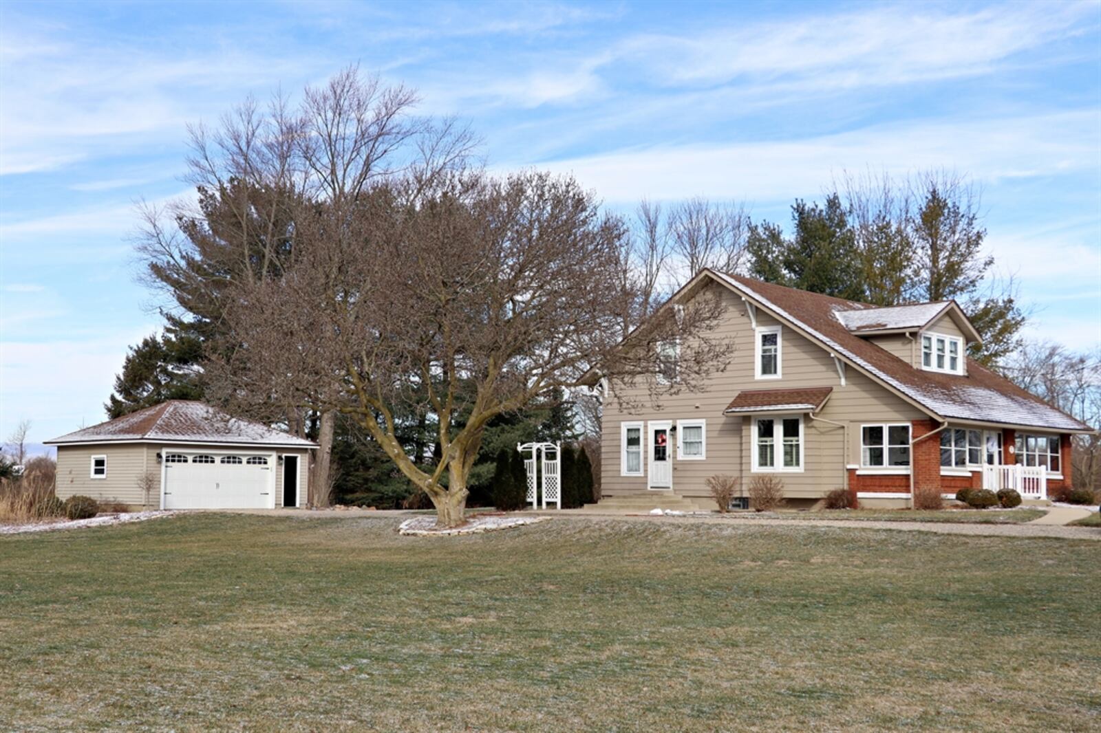 A canopy of mature trees create a backdrop to the 1.97-acre property, which includes a two-car detached garage, a cabin with wood-burning stove and skylights, and a 63-by-33-foot workshop with four-car bay and professional detailing paint booth.