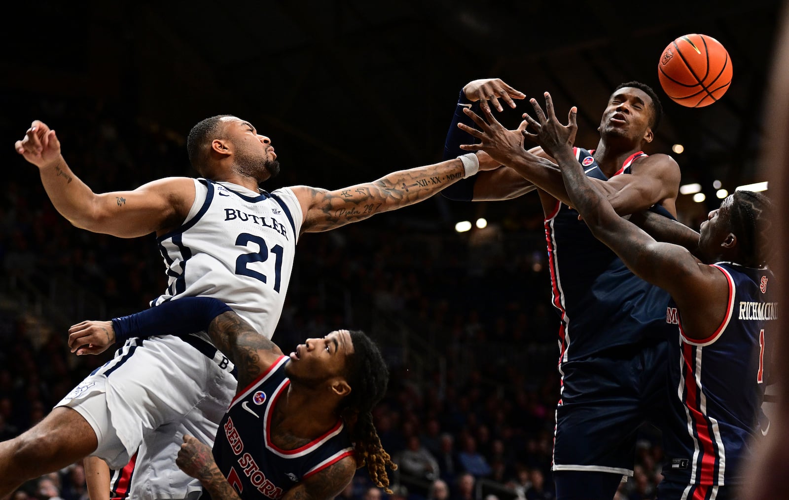 Butler ath Dante Maddox Jr. (21) knocks a rebound away from St. John's center Vince Iwuchukwu during the first half of an NCAA college basketball game, Wednesday, Feb. 26, 2025, in Indianapolis, Ind. (AP Photo/Marc Lebryk)