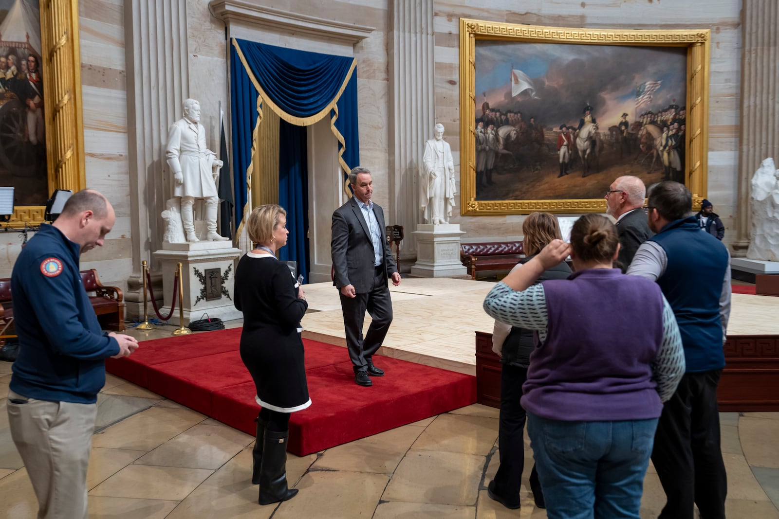 Officials inspect the construction of a stand in the Rotunda, where President-elect Donald Trump is due to take the oath of office on Monday, at the Capitol in Washington, Friday, Jan. 17, 2025. (AP Photo/Ben Curtis)