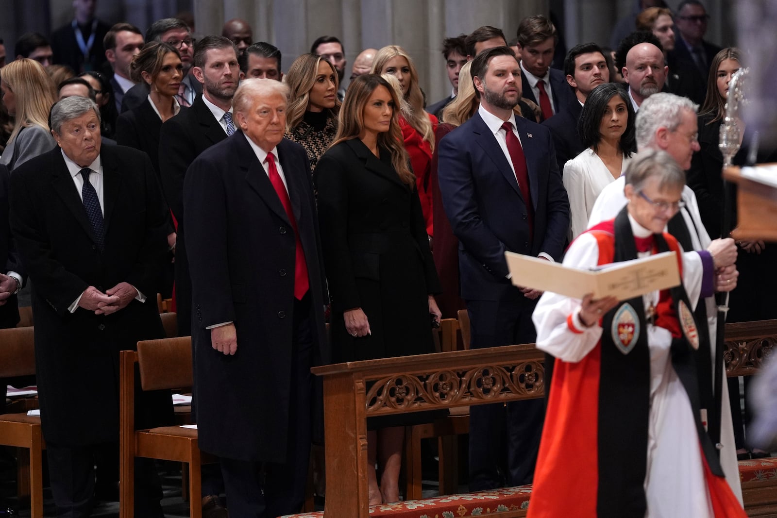 President Donald Trump, from front row left, first lady Melania Trump, Vice President JD Vance and his wife Usha Vance look on as Rev. Mariann Budde, right, arrives at the national prayer service at the Washington National Cathedral, Tuesday, Jan. 21, 2025, in Washington. (AP Photo/Evan Vucci)