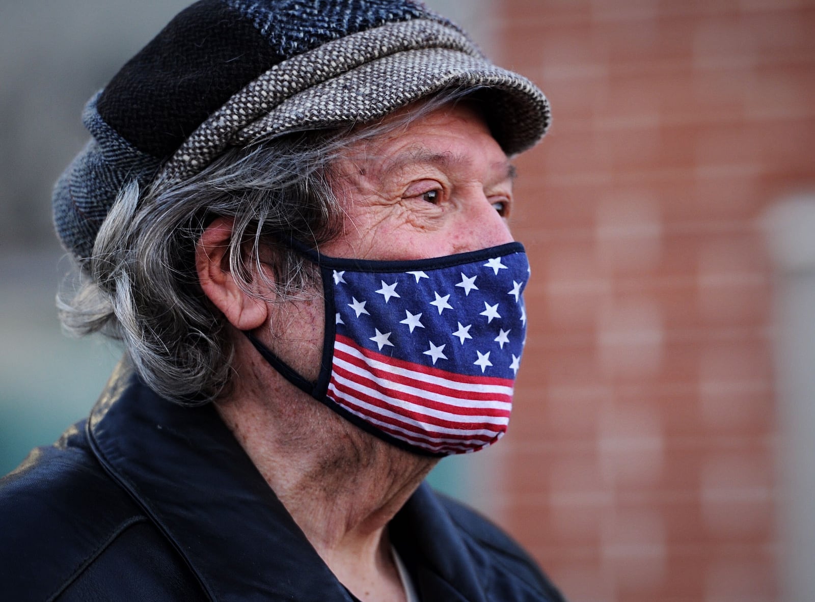 James Wilkerson wears his patriotic mask while waiting in line to vote at the library on Watervliet Avenue on Tuesday, Nov. 3, 2020. MARSHALL GORBY\STAFF