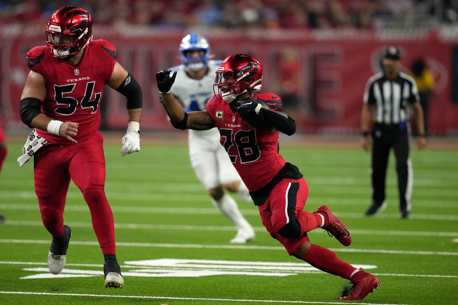 Houston Texans running back Joe Mixon (28) runs for a first down during the first half of an NFL football game against the Detroit Lions, Sunday, Nov. 10, 2024, in Houston. (AP Photo/David J. Phillip)