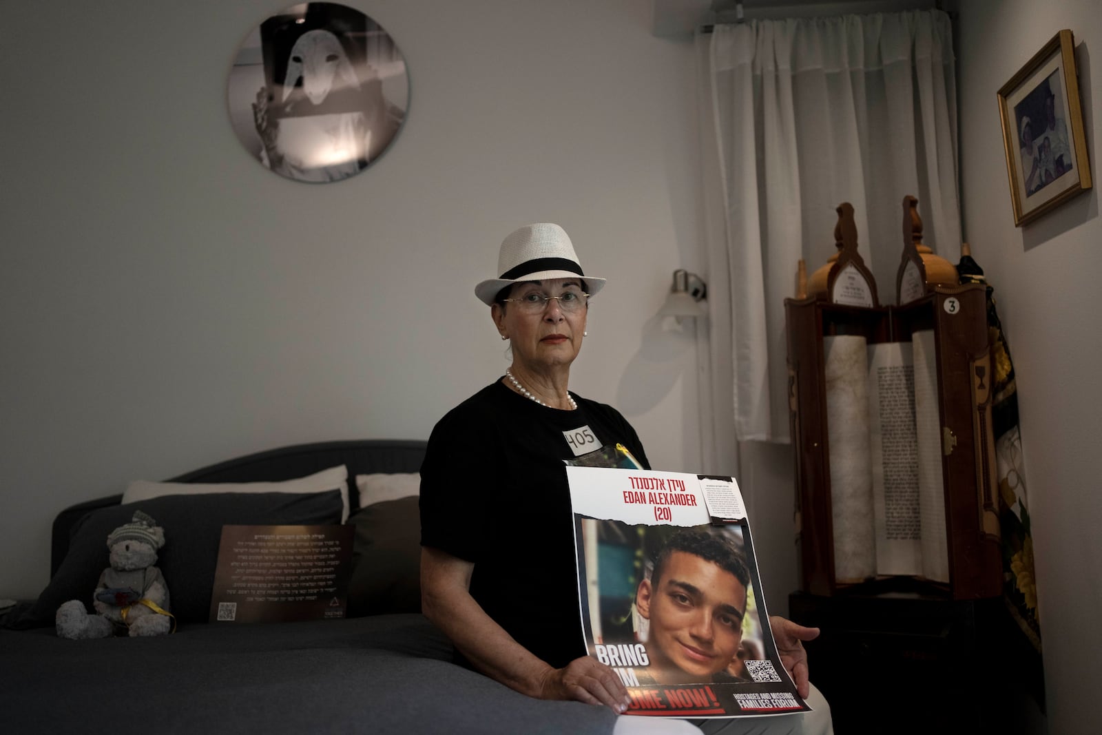 Varda Ben Baruch, whose grandson Edan Alexander is held hostage in the Gaza Strip by Hamas militants, poses for a portrait in his bedroom at home in Tel Aviv, Israel, Thursday, Nov. 14, 2024. (AP Photo/Maya Alleruzzo)