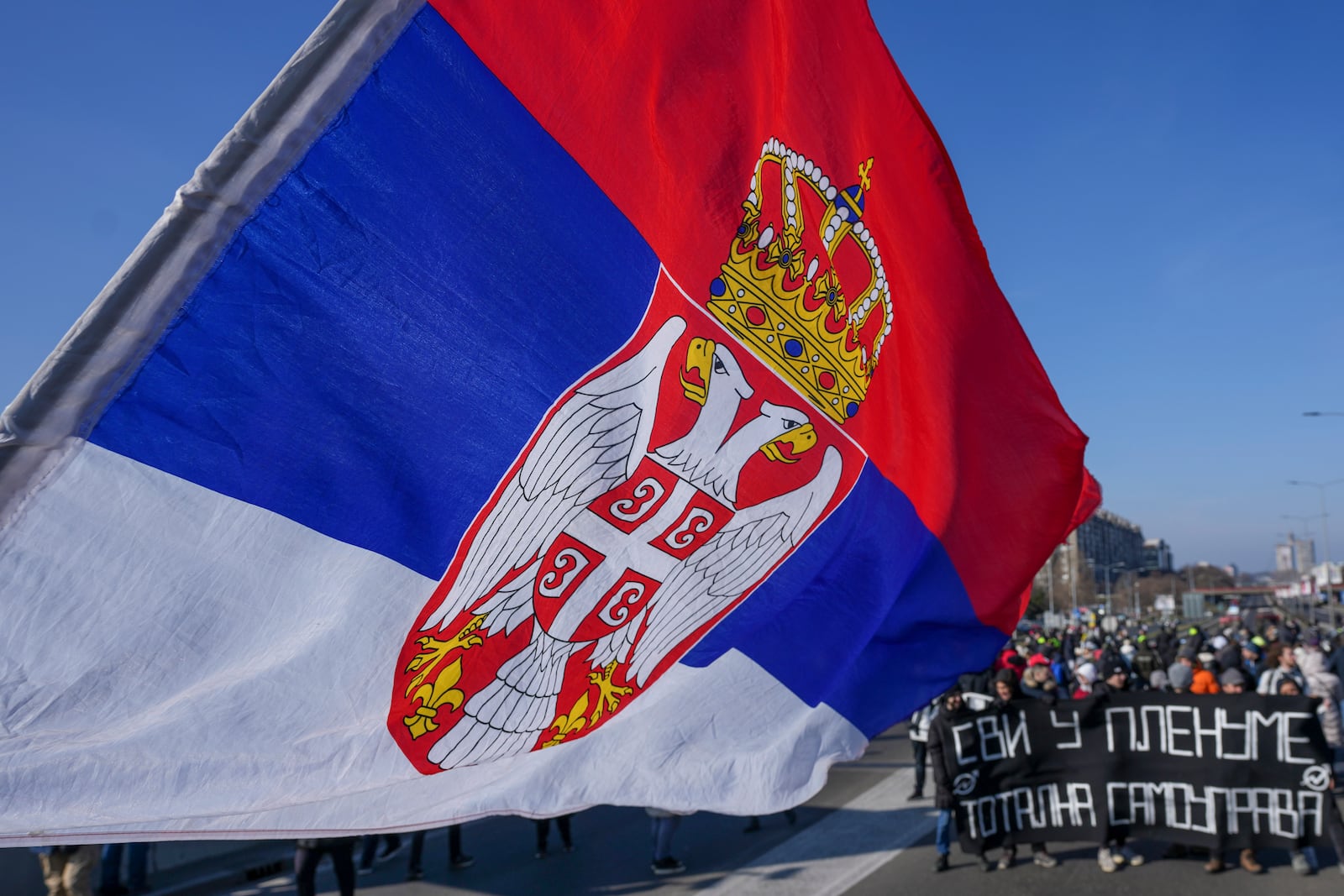 People participate in a 7-hour long blockade of a highway in Belgrade, Serbia, Sunday, Feb. 9, 2025, to protest the Nov. 1. collapse of a concrete canopy at the central train station in Novi Sad, that killed 15 people. (AP Photo/Darko Vojinovic)