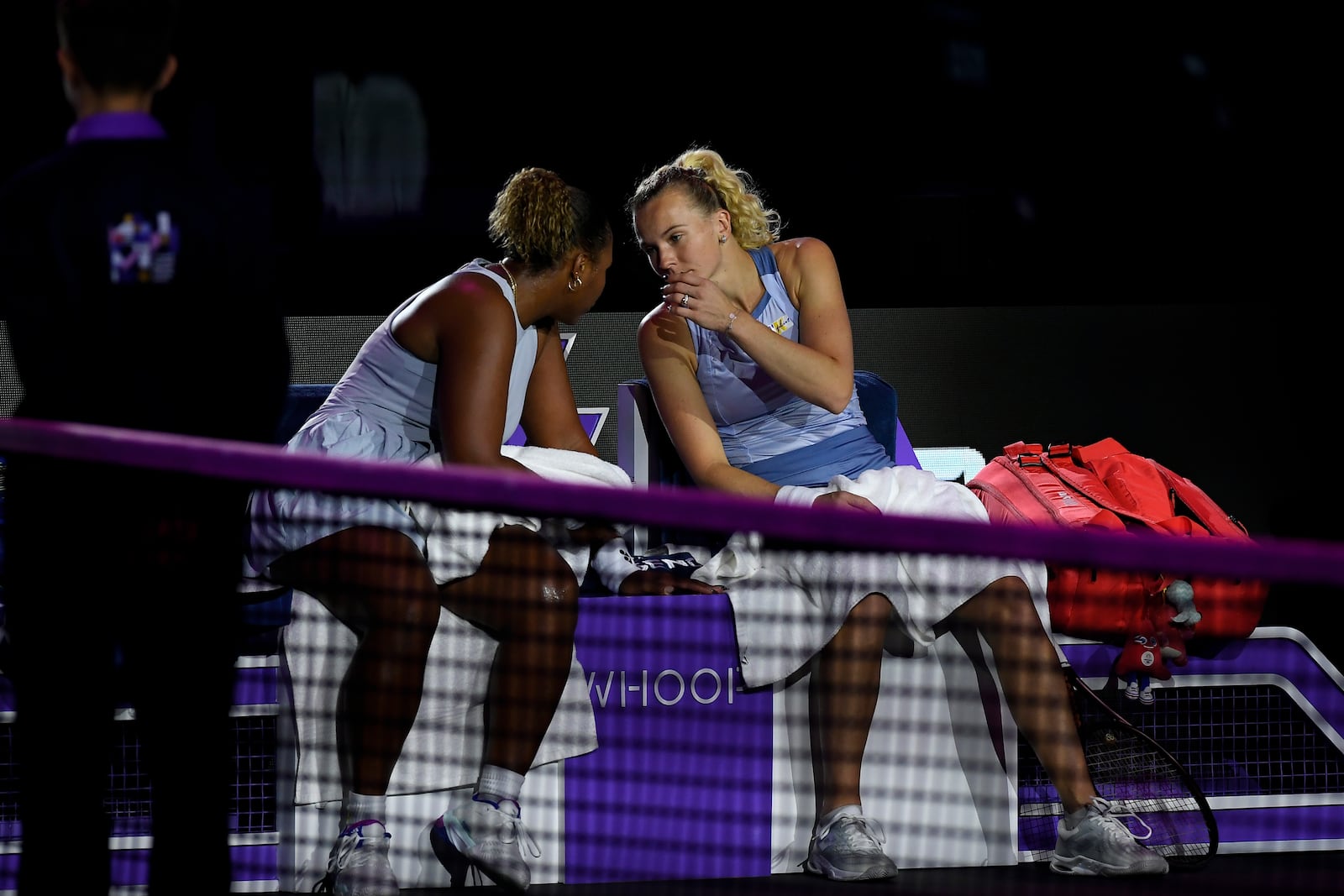 Taylor Townsend of the U.S., left, and Katerina Siniakova of the Czech Republic talk to each other during a changeover in their women's doubles match against New Zealand's Erin Routliffe and to Canada's Gabriela Dabrowski in the final of the WTA finals at King Saud University Indoor Arena, in Riyadh, Saudi Arabia, Saturday, Nov. 9, 2024. (AP Photo)