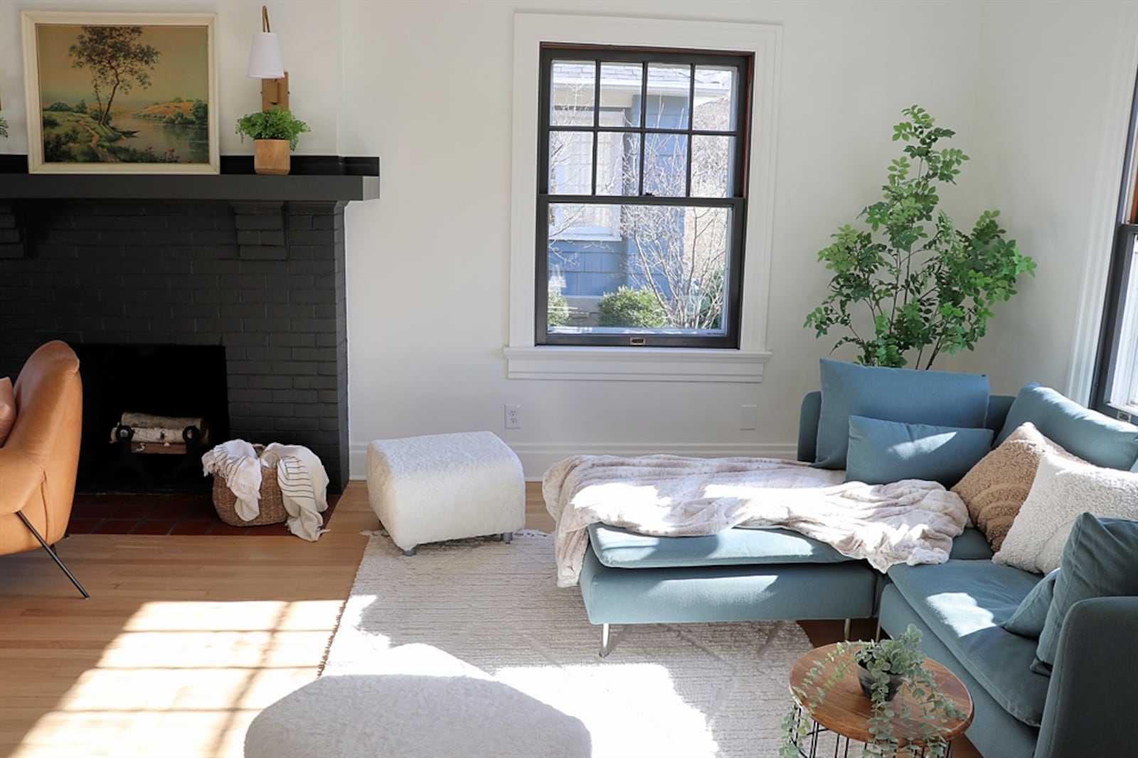 The fireplace is flanked by windows with additional windows to the front and back, filling the room with plenty of natural light.