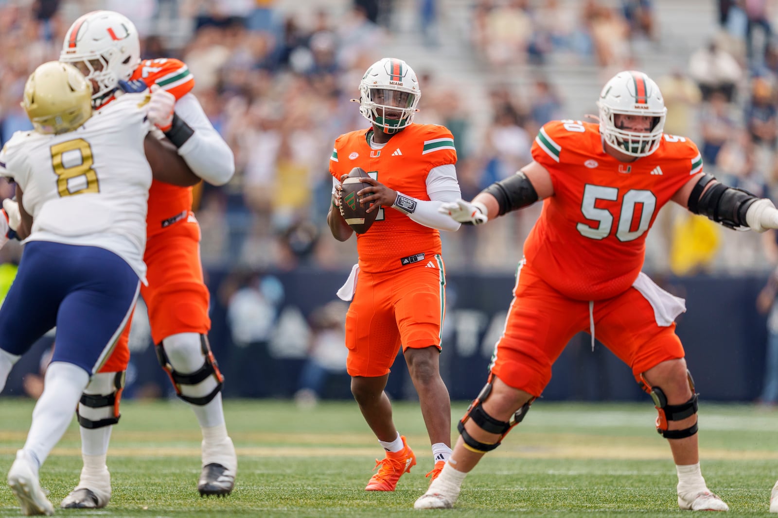 Miami quarterback Cam Ward (1) drops back to throw during the first half of an NCAA college football game against Georgia Tech, Saturday, Nov. 9, 2024, in Atlanta. (AP Photo/Jason Allen)