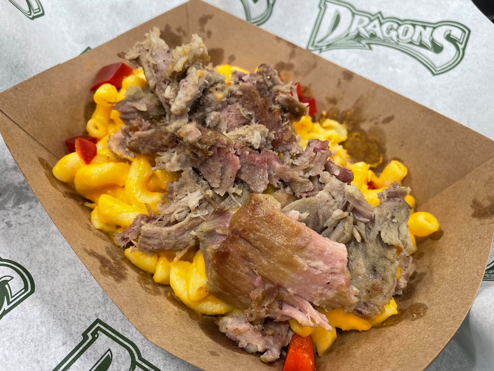 Opening Day is right around the corner at Day Air Ballpark. Pictured is a Smoked Pulled Pork Mac and Cheese Bowl. NATALIE JONES/STAFF