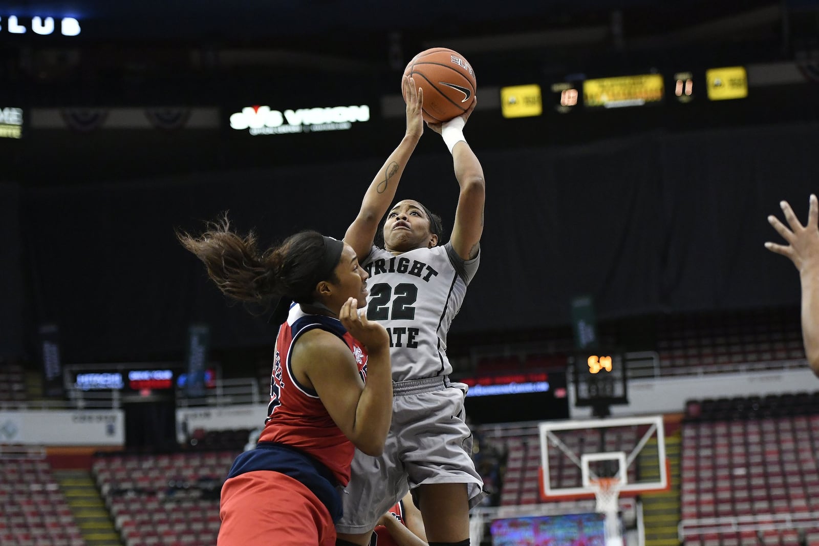 Wright State’s Chelsea Welch puts up a shot over Detroit’s Kelsey Mitchell during the Raiders’ 71-52 loss in the Horizon League semifinals Monday at Joe Louis Arena in Detroit. JOSE JUAREZ/CONTRIBUTED PHOTO.