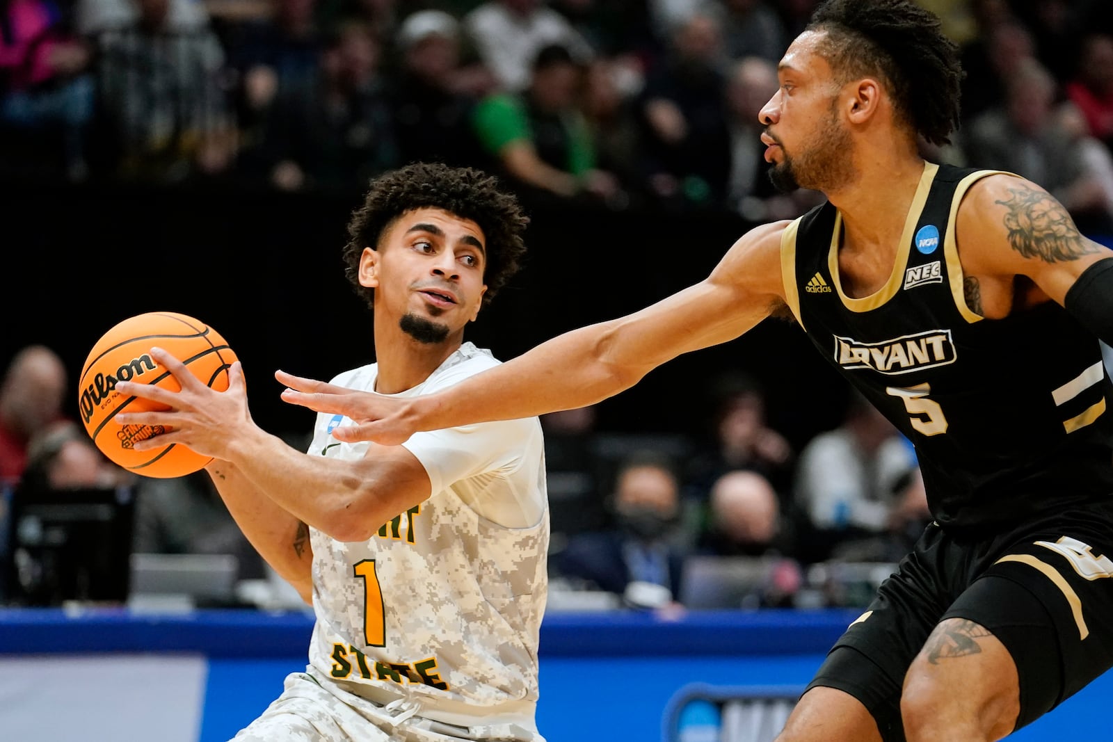 Wright State guard Trey Calvin (1) drives past Bryant's Charles Pride (5) during the second half of a First Four game in the NCAA men's college basketball tournament, Wednesday, March 16, 2022, in Dayton, Ohio. (AP Photo/Jeff Dean)