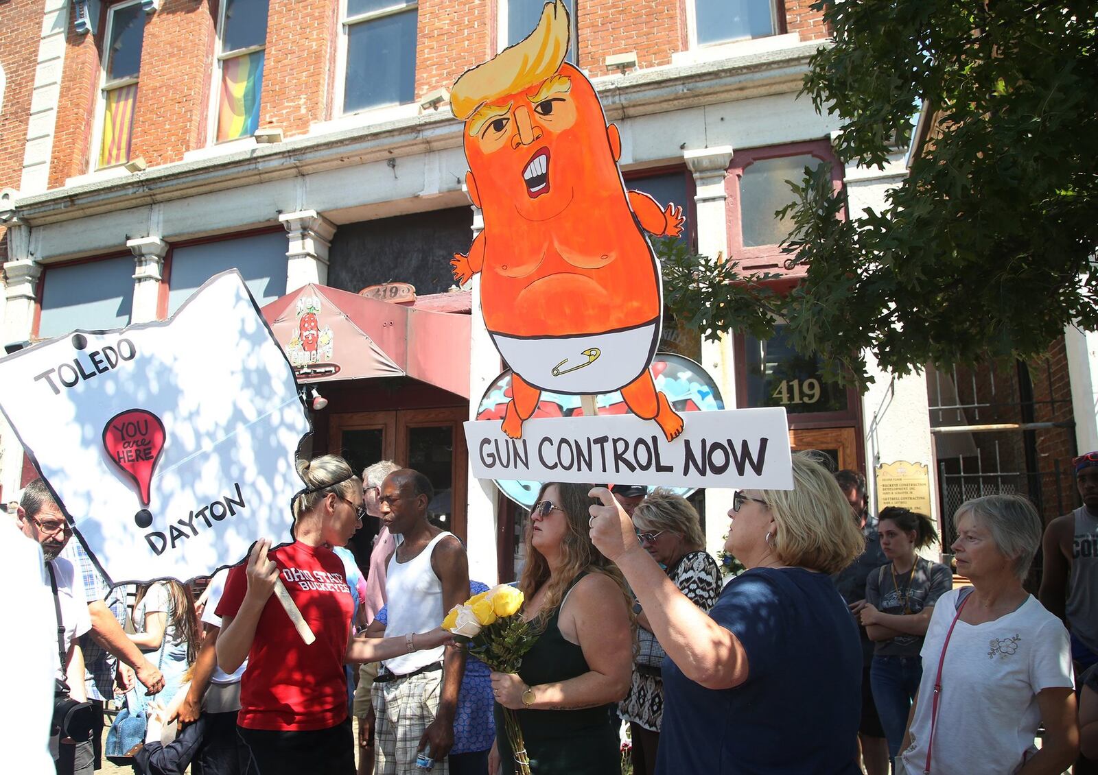 Dayton’s Oregon District was filled with demonstrators Wednesday as President Donald Trump and first lady Melania Trump visited the city. The visit came just days after a mass shooting in the district that left nine people dead and dozens injured. LISA POWELL / STAFF