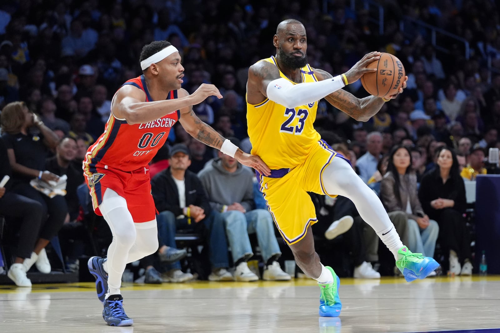 Los Angeles Lakers' LeBron James (23) drives past New Orleans Pelicans' Bruce Brown (00) during the second half of an NBA basketball game Tuesday, March 4, 2025, in Los Angeles. (AP Photo/Jae C. Hong)