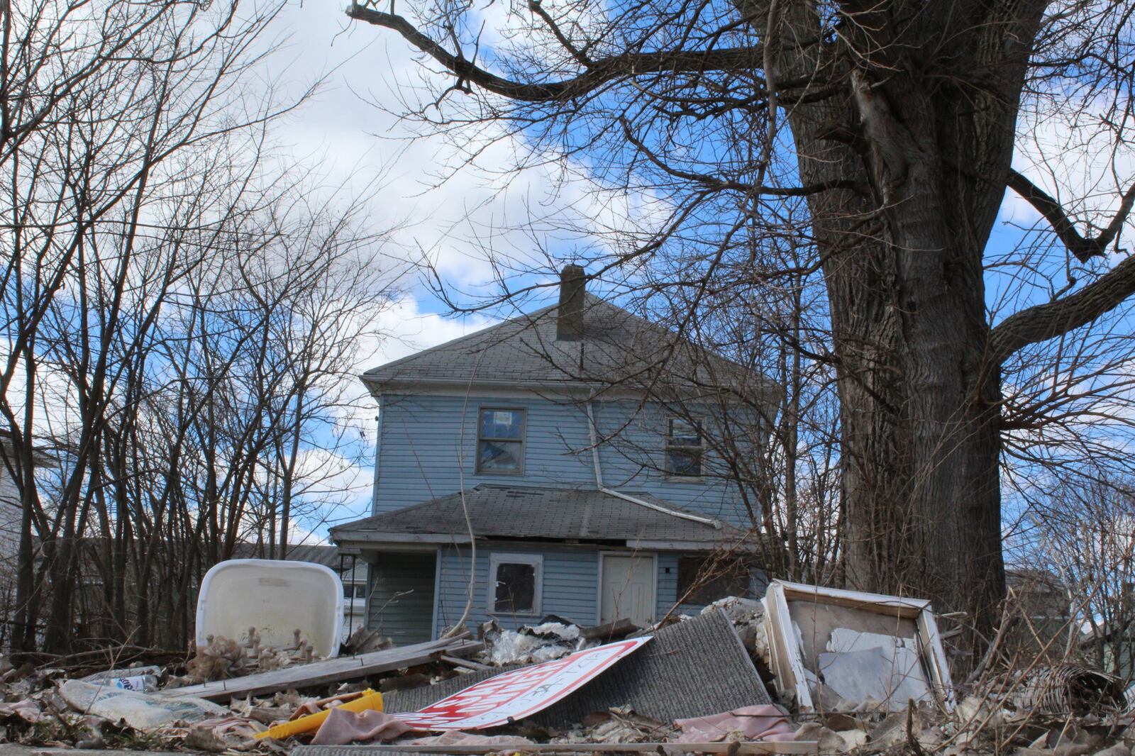 Neighborhoods Over Politics has asked the city of Dayton to modify strategies for how it cleans up local neighborhoods. This abandoned home on Wisconsin Boulevard has trash in the backyard and debris all around it. CORNELIUS FROLIK / STAFF