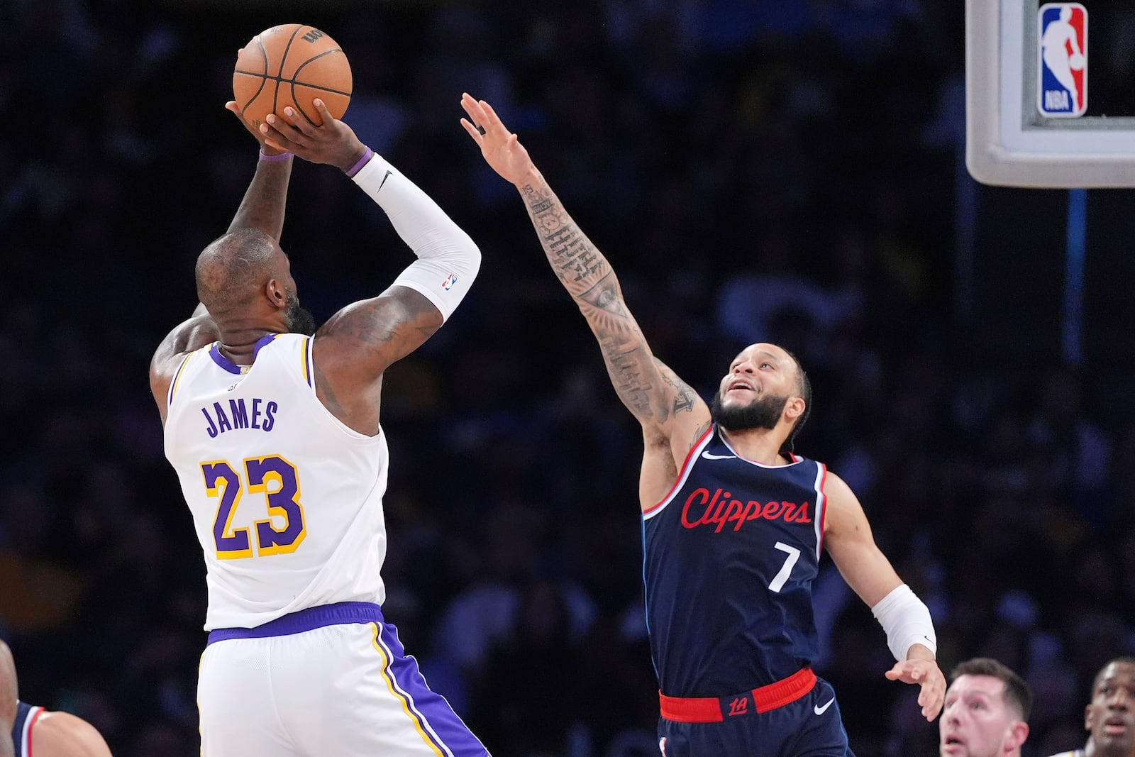 Los Angeles Lakers forward LeBron James, left, shoots as Los Angeles Clippers guard Amir Coffey defends during the first half of an NBA basketball game Sunday, March 2, 2025, in Los Angeles. (AP Photo/Mark J. Terrill)