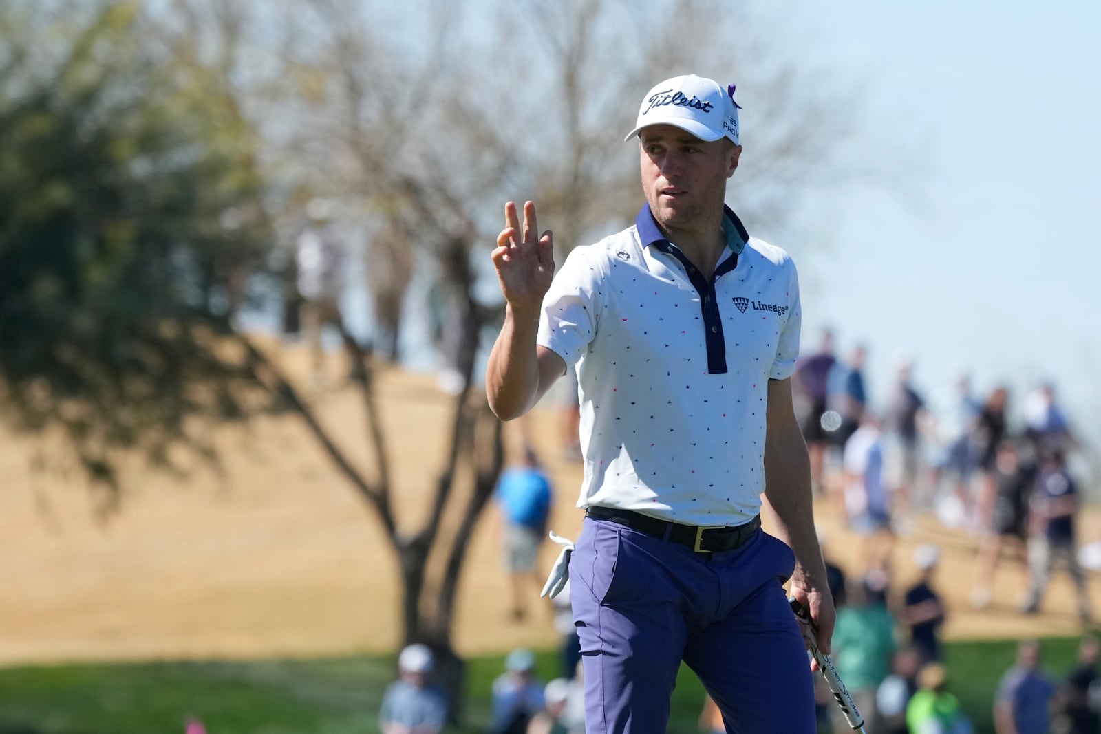 Justin Thomas waves to the crowd after making a birdie on the ninth hole during the first round of the Waste Management Phoenix Open PGA Tour golf tournament at the TPC Scottsdale Thursday, Feb. 6, 2025, in Scottsdale, Ariz. (AP Photo/Ross D. Franklin)