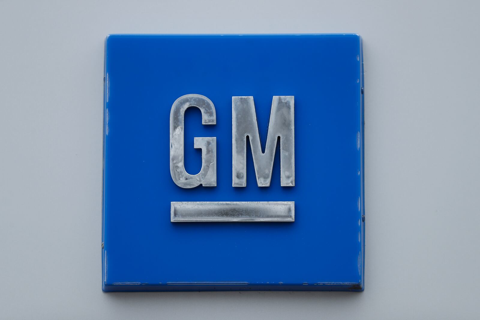 FILE - A GM logo is shown at the General Motors Detroit-Hamtramck Assembly plant in Hamtramck, Mich., Jan. 27, 2020.   General Motors and a joint venture partner plan to build an electric vehicle battery factory in Lansing, Michigan, which would be their third such factory in the U.S. The companies' plans were revealed in documents posted on the city’s website Friday, Dec. 10, 2021.  (AP Photo/Paul Sancya, file)