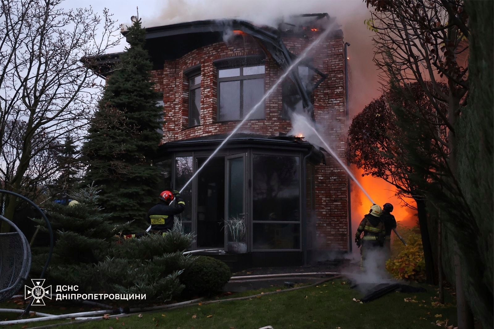 In this photo provided by the Ukrainian Emergency Services on Nov. 21, 2024, rescue workers put out a fire of a burning house damaged by a Russian strike on Dnipro, Ukraine. (Ukrainian Emergency Service via AP)