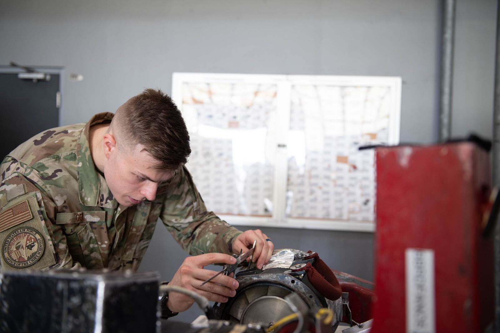 Second Lt. Jacob Geil, Project Arc engineer, measures part of a ram air scoop fan assembly Sept. 22, 2022, as part of an initiative to embed engineers at operational wings to solve technical problems. As part of the Project Arc program, Geil and his teammate were stationed at Barksdale Air Force Base, La., for six months to help develop, test and transition Airmen and commercial solutions. (U.S. Air Force photo by Staff Sgt. Christopher Tam)