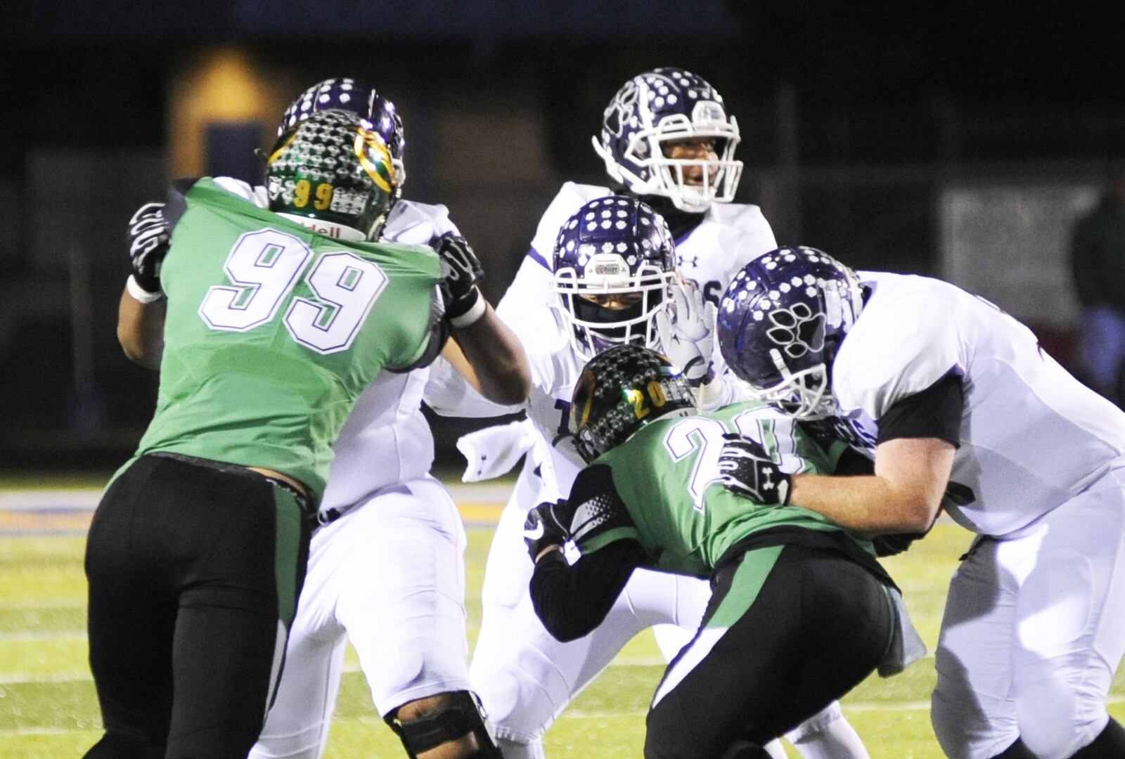 Northmont’s Gabe Newburg (99) and Andrew Knick (20) put the heat on Central QB Demeatric Crenshaw. Pickerington Central defeated Northmont 33-7 in a D-I, Region 3 semifinal at Springfield s Evans Stadium on Friday, Nov. 9, 2018. MARC PENDLETON / STAFF