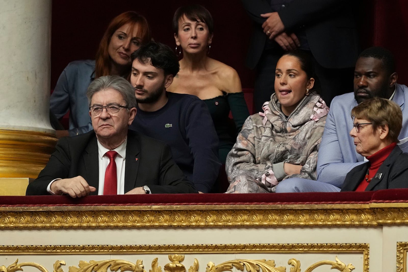 French far-left leader Jean-Luc Melenchon, left, listens to speeches from the tribunes at the National Assembly prior to a no-confidence vote that could bring down the Prime Minister and the government for the first time since 1962, Wednesday, Dec. 4, 2024 in Paris. (AP Photo/Michel Euler)