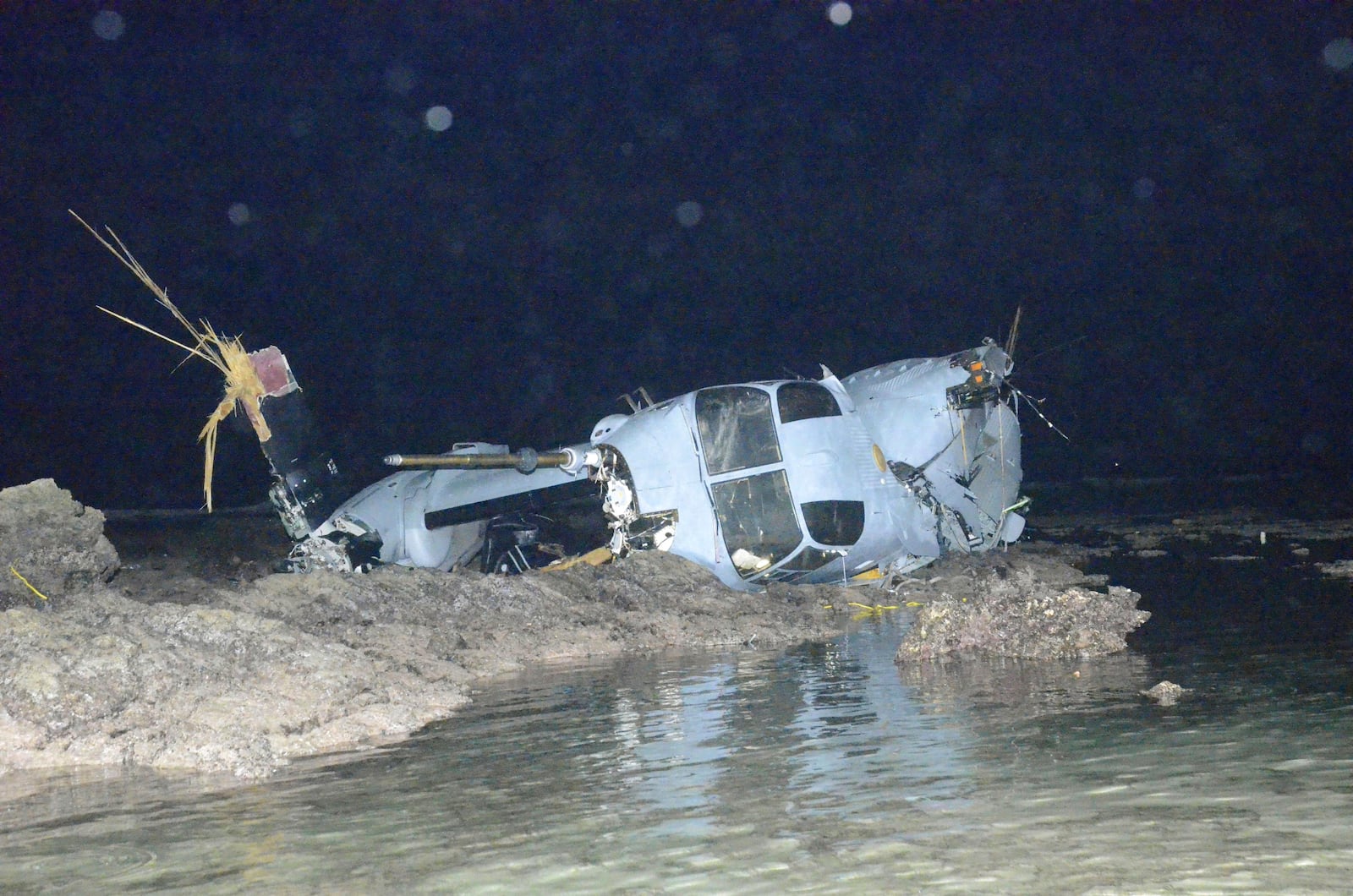 FILE - Wreckage of a MV-22 Osprey is seen in shallow waters off Nago, Okinawa, southern Japan, Dec. 14, 2016, after it crash landed. All five crew members were safely rescued. (Ryukyu Shimpo/Kyodo News via AP)