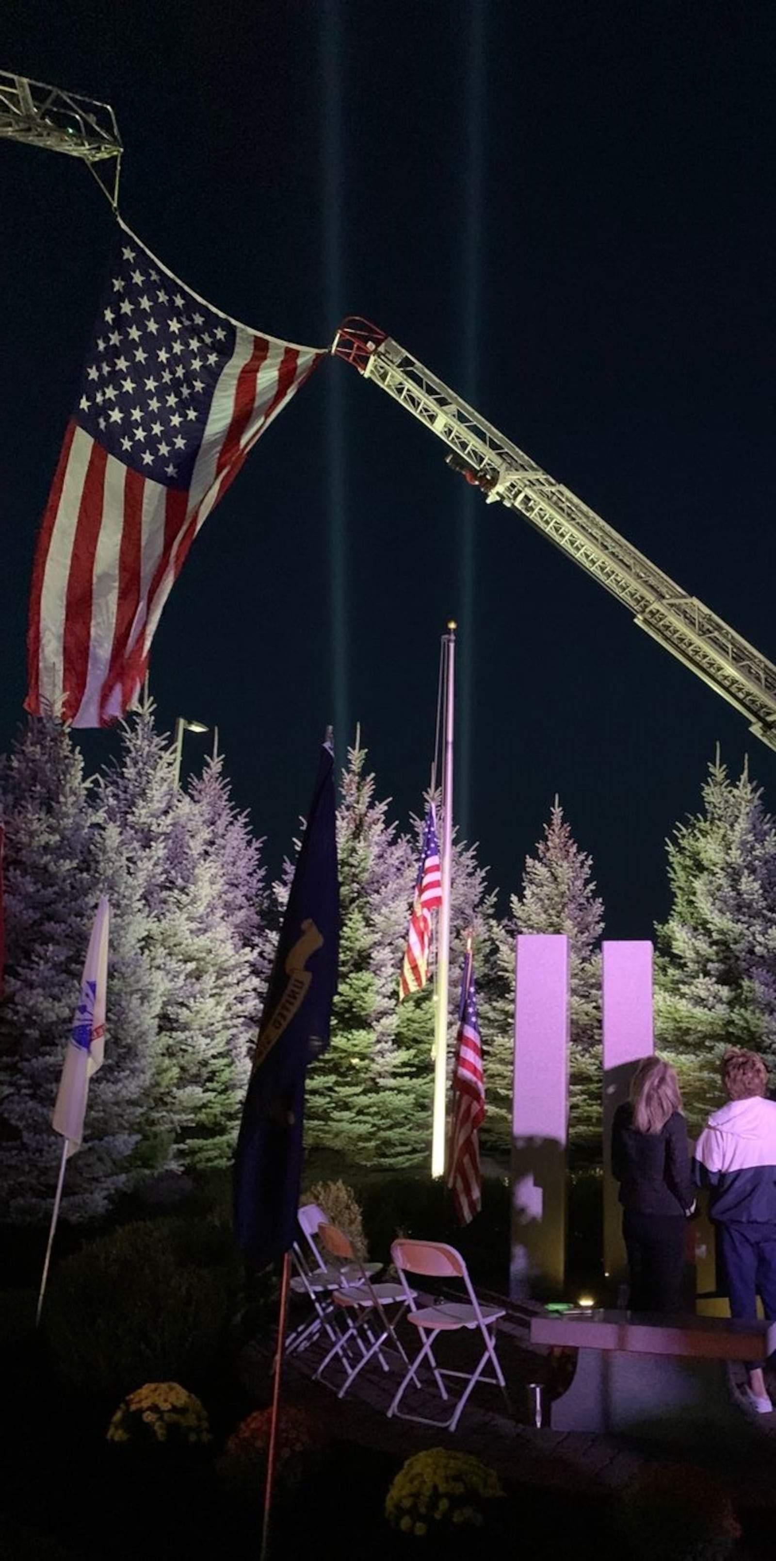 Two beams of light point skyward at the conclusion of Friday's 9/11 remembrance at the Warren County 9/11 Memorial in Lebanon. The remembrance featured music, remarks by officials and a candlelight vigil. ED RICHTER/STAFF