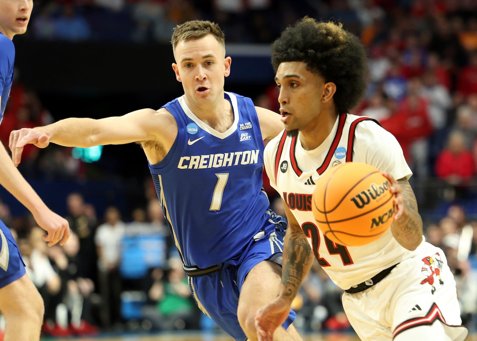 Louisville's Chucky Hepburn, right, drives past Creighton's Steven Ashworth (1) during the first half in the first round of the NCAA college basketball tournament in Lexington, Ky., Thursday, March 20, 2022. (AP Photo/James Crisp)