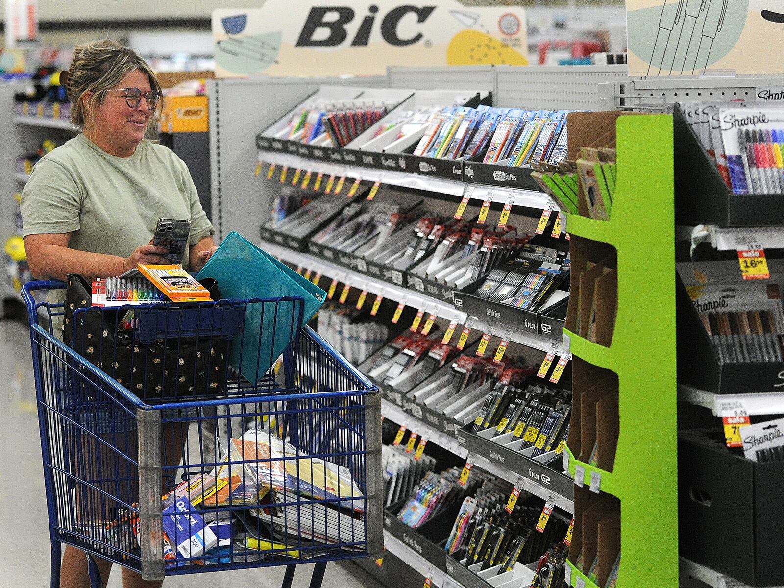 Crystal Houser, of Kettering, shops for school supplies for her two children at the Meijer store located at 4075 Wilmington Pike in Kettering Tuesday, July 25, 2023. Ohio’s Sales Tax Holiday runs from Aug. 4 through Aug. 6. Tax-free items include school supplies and books that cost $20 or less per item and clothing at $75 or less per item. MARSHALL GORBY/STAFF