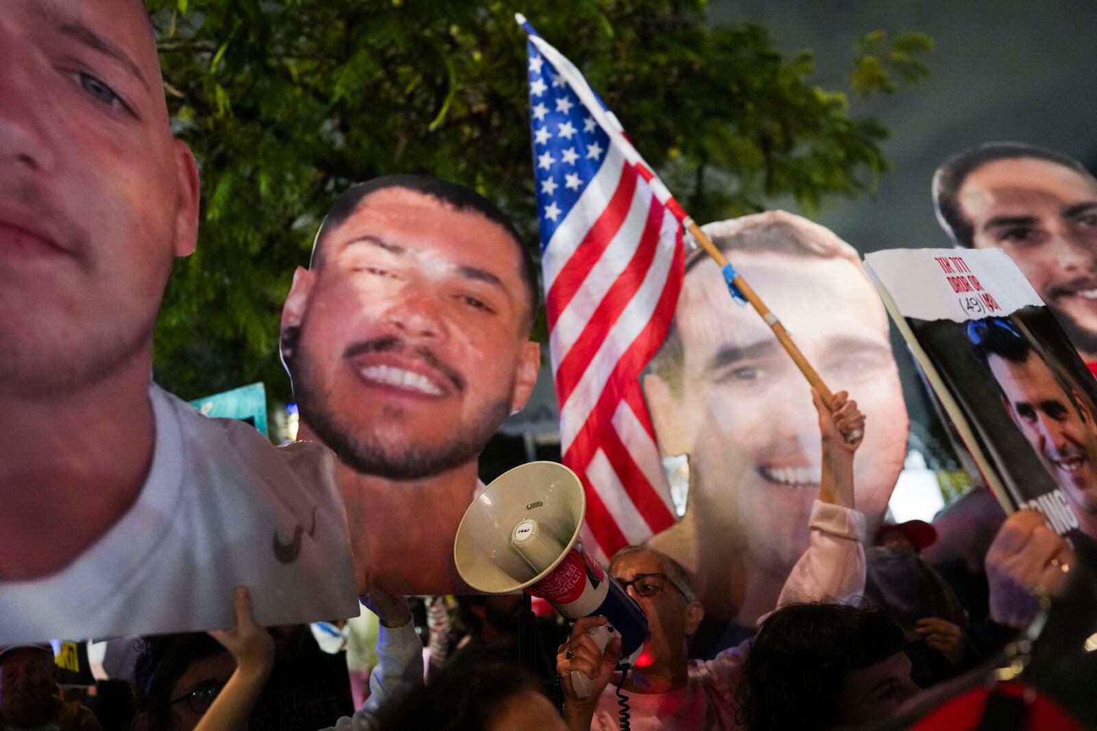 People wave the U.S. flag and hold photos of hostages held by Hamas in Gaza, during a rally calling for their return, in Tel Aviv, Israel, Tuesday, Feb. 4, 2025, ahead of the planned meeting between U.S. President Donald Trump and Israeli Prime Minister Benjamin Netanyahu. (Photo/Ohad Zwigenberg)